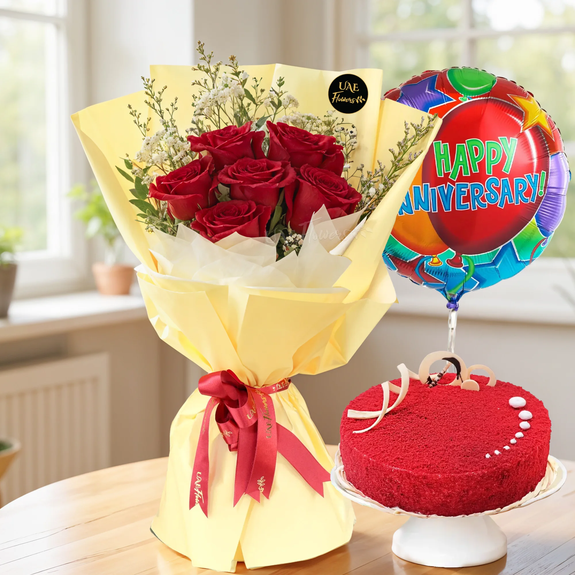 Bouquet of 12 red roses with green fillers in nice wrapping,  1 kg red velvet cake and HAPPY ANNIVERSARY foil balloon.
