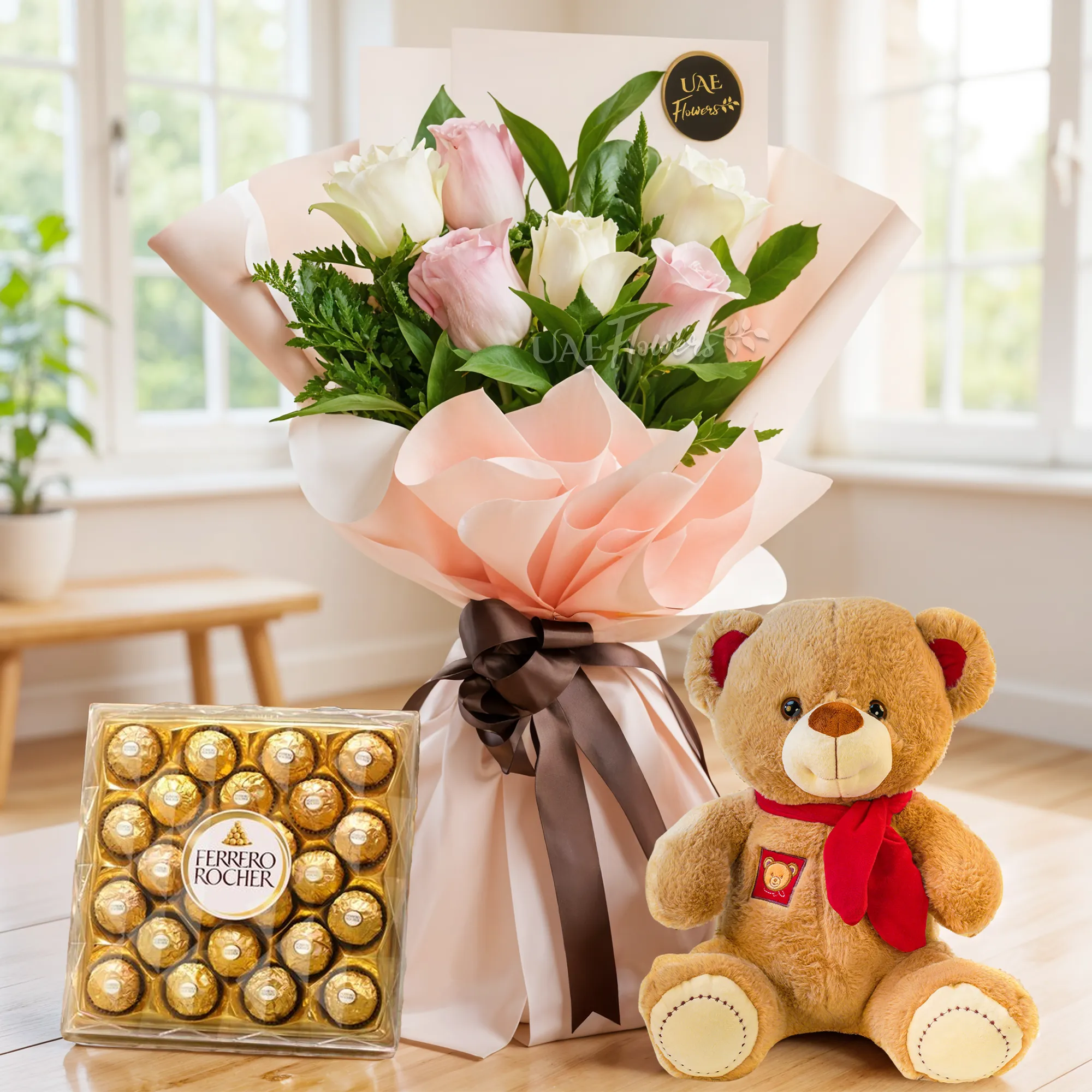 Bouquet of 6 pink & white roses with green fillers in paper packing tied with ribbons with small teddy bear and 24 pcs ferrero rocher chocolate.