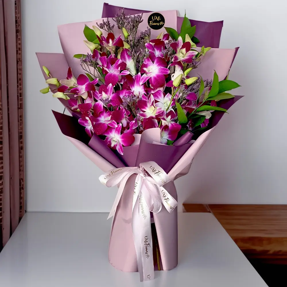 Bouquet of 10 purple orchids with green fillers in nice wrapping, a small teddy bear and HAPPY BIRTHDAY foil balloon.