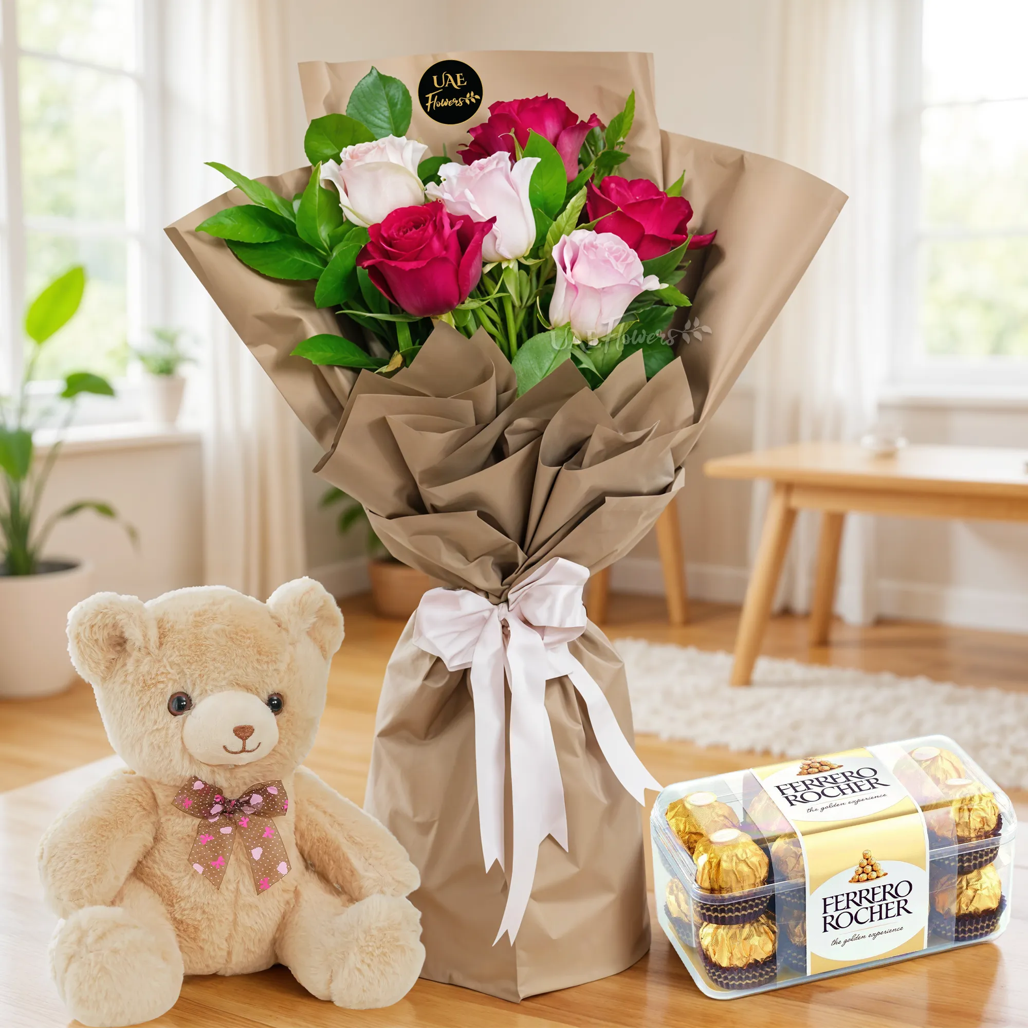 Bouquet of 6 red & pink roses with green fillers in paper packing tied with ribbons with a small teddy bear and 16 pcs ferrero rocher chocolate.