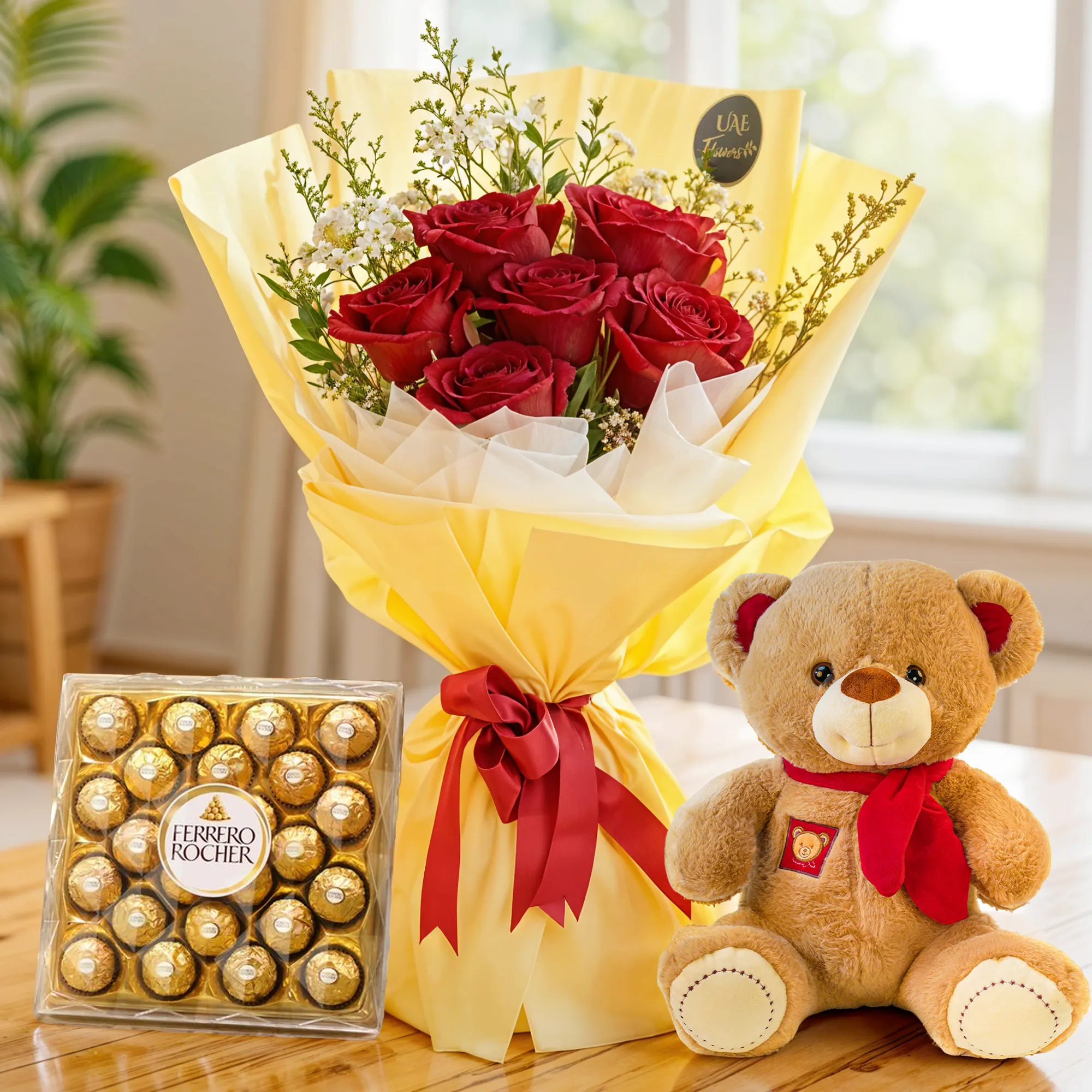Bouquet of 6 red roses with limonium & green fillers in paper packing tied with ribbons with a small teddy bear and 24 pcs ferrero rocher chocolate.