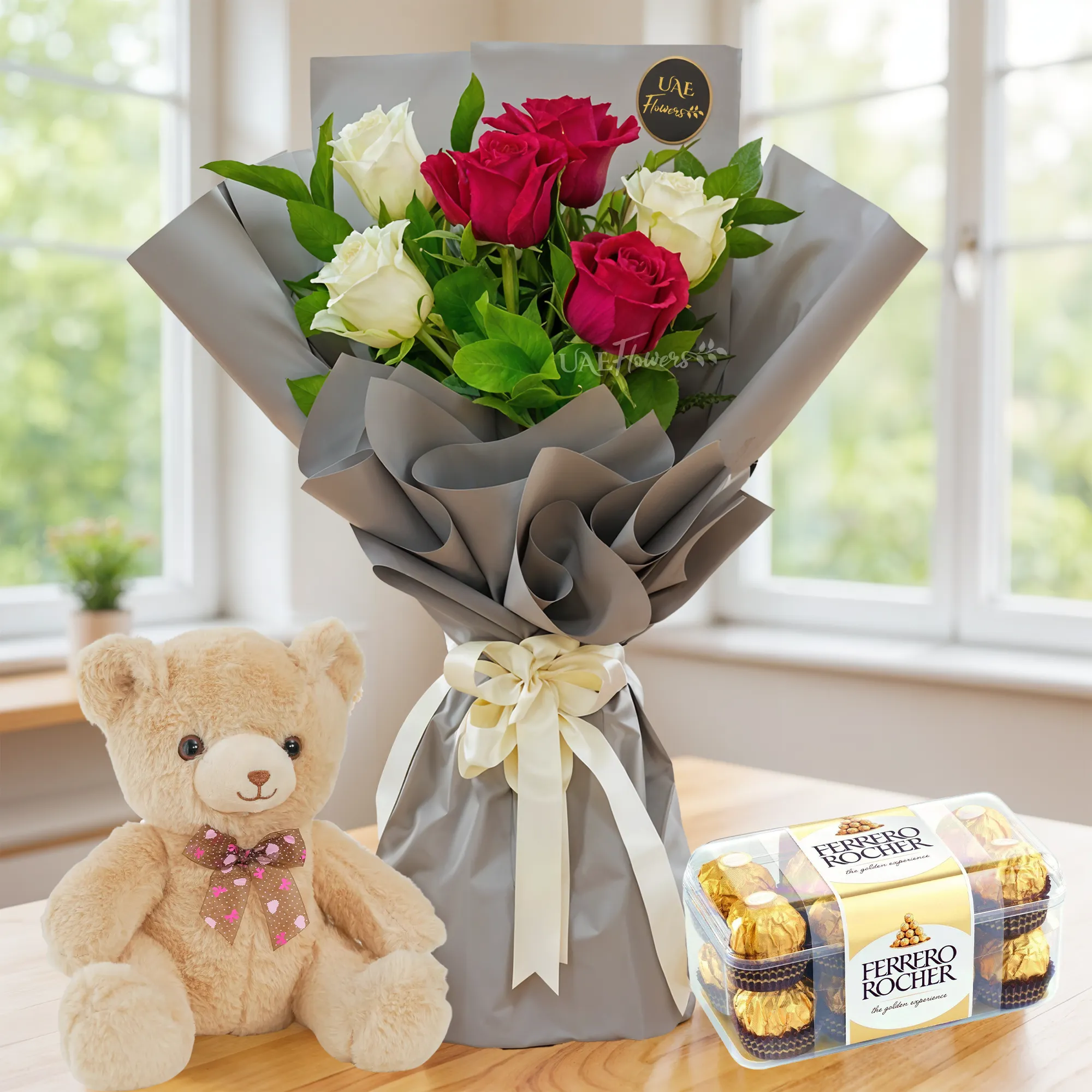 Bouquet of 6 white and red roses with green fillers in paper packing with ribbons with small teddy bear and 16 pcs ferrero rocher chocolate.