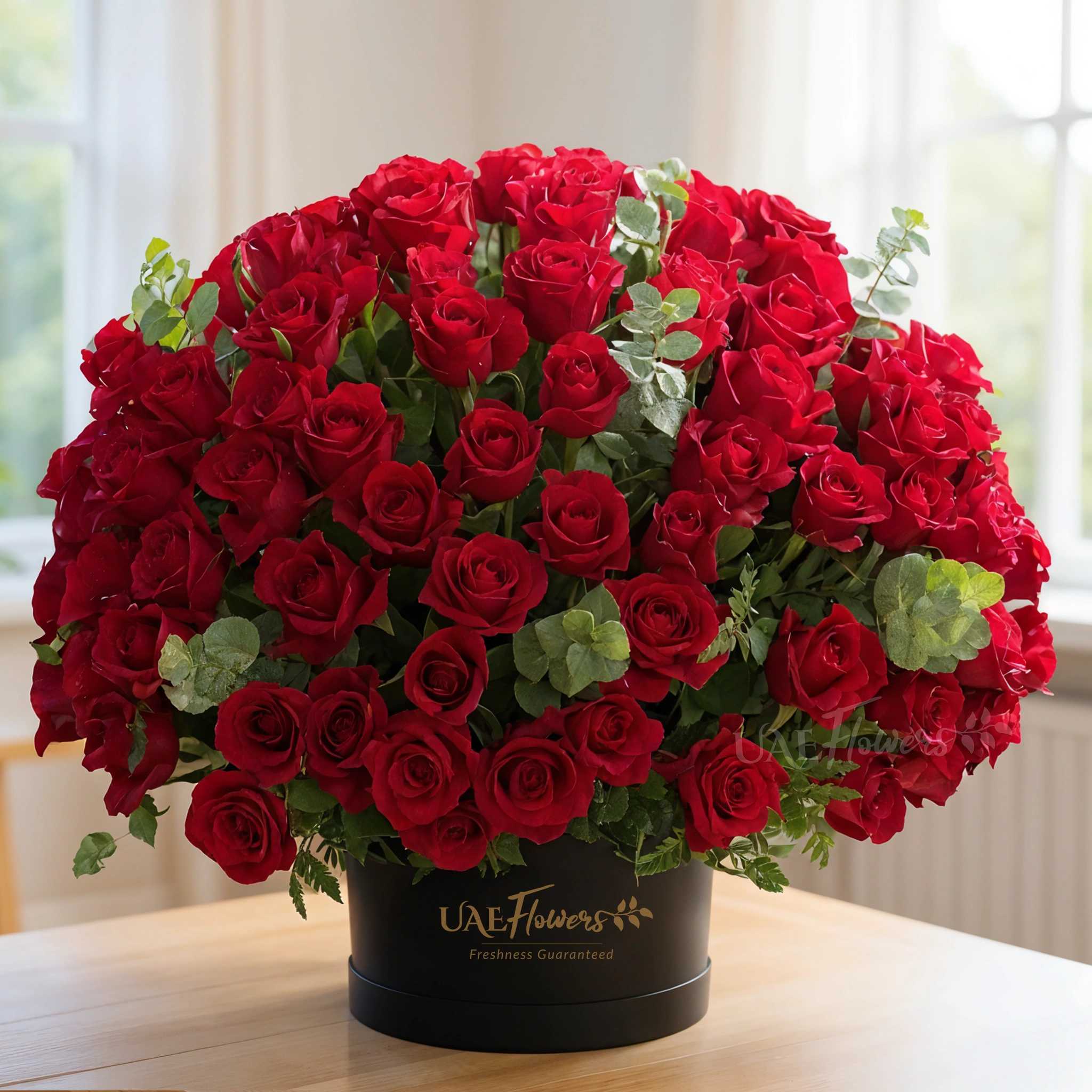 200 stems of red roses with eucalyptus leaf in a black box.