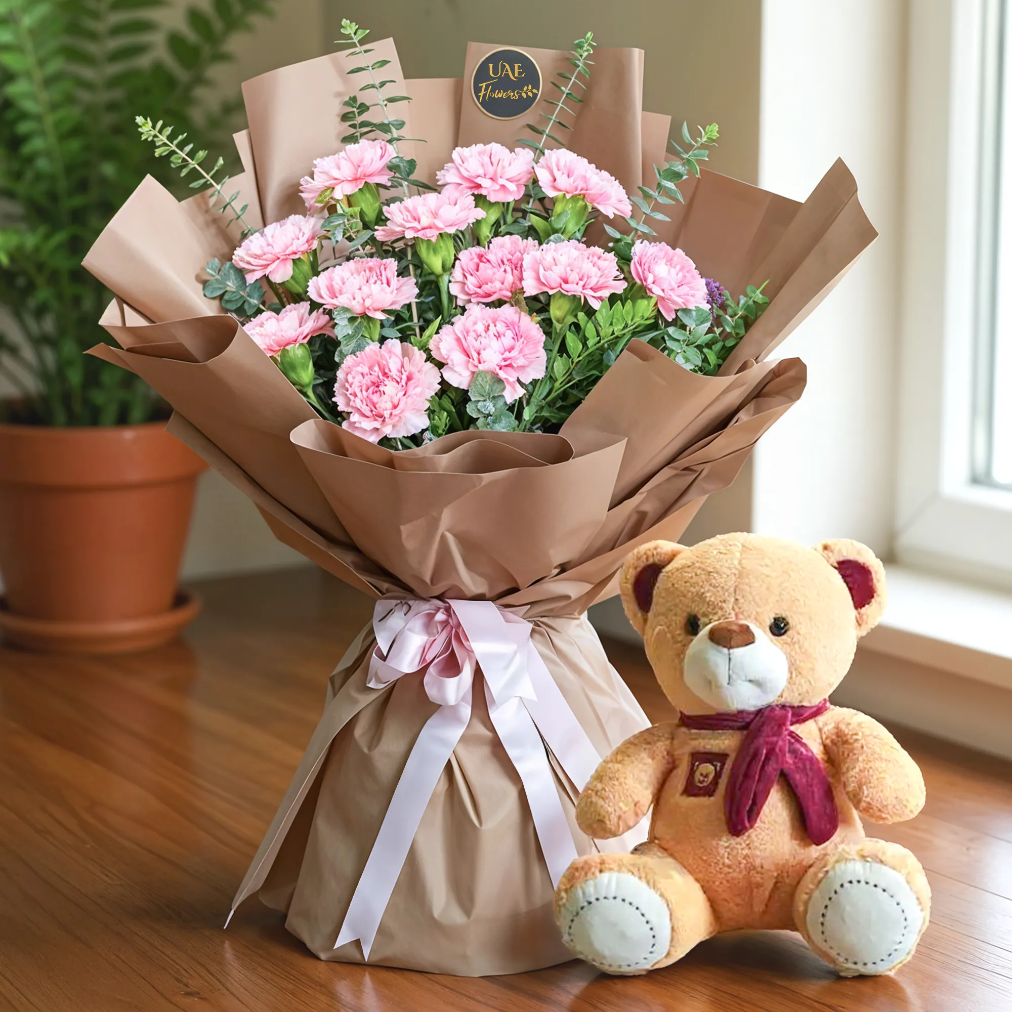 Bouquet of 12 pink carnations with green fillers in nice wrapping and a small teddy bear.