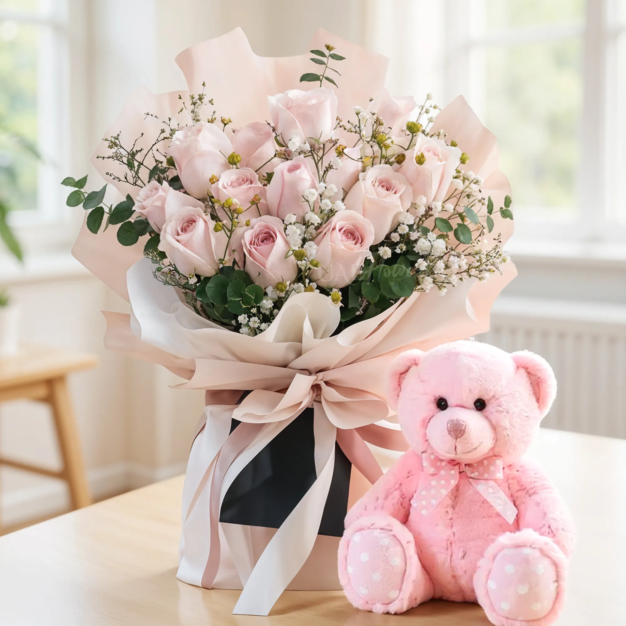 Bouquet of 12 Pink Roses with fillers in nice wrapping along with a small pink teddy bear.