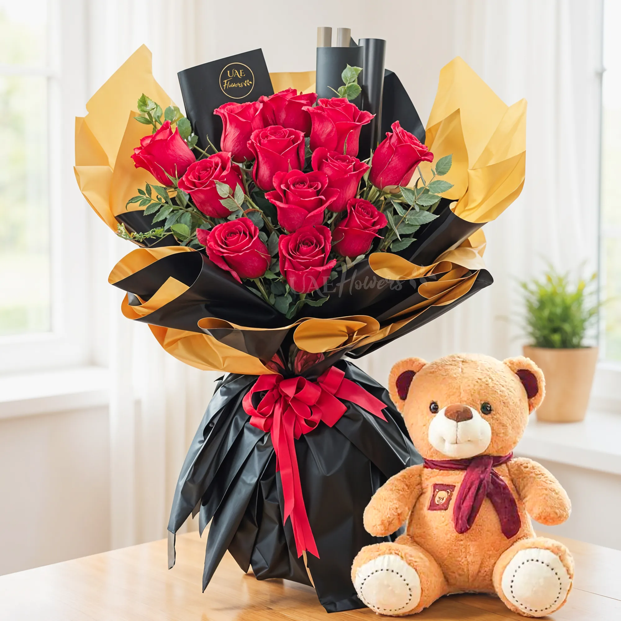 Bouquet of 12 red roses with green fillers in nice wrapping and a small brown teddy bear.