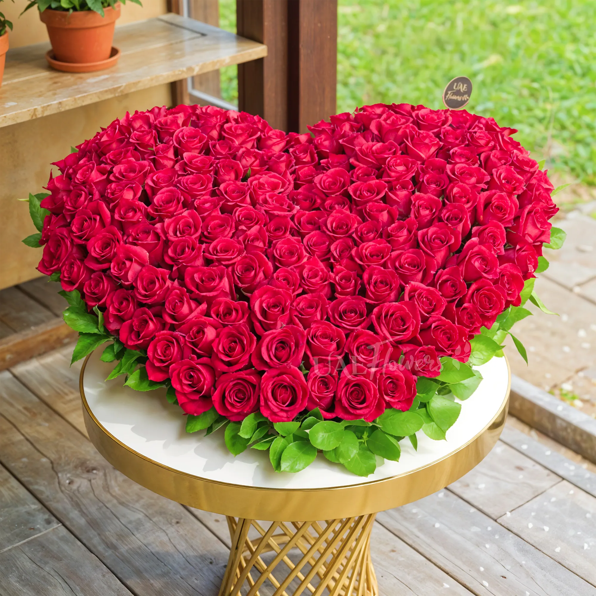 Heart Shaped arrangement of 100 Red Roses with fillers