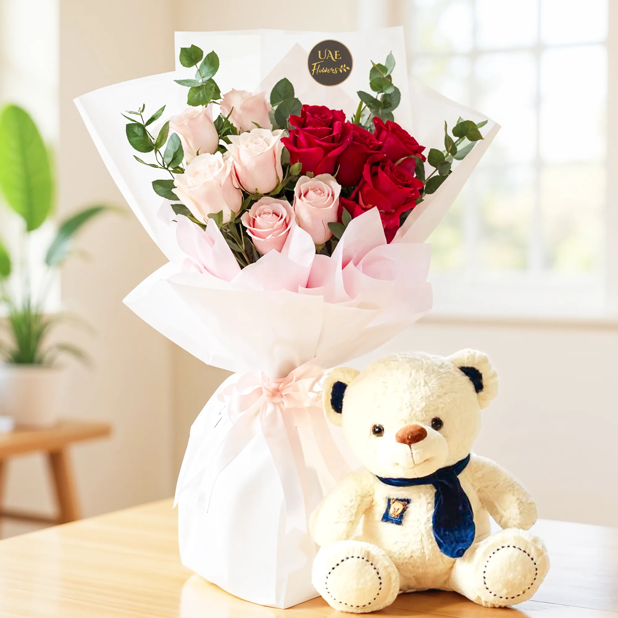 Bouquet of 12 red & pink roses with green fillers in nice wrapping and a small white teddy bear.