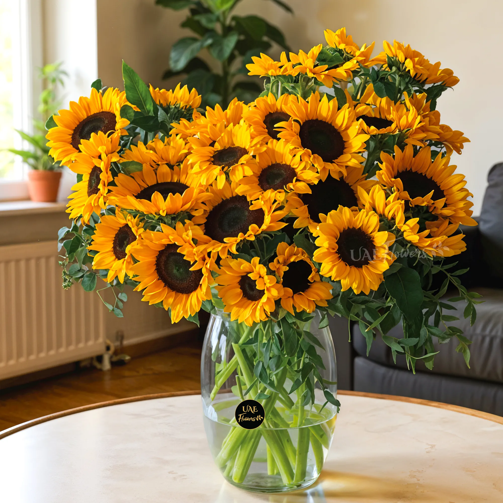 25 stems of bright yellow sunflowers in a glass vase.