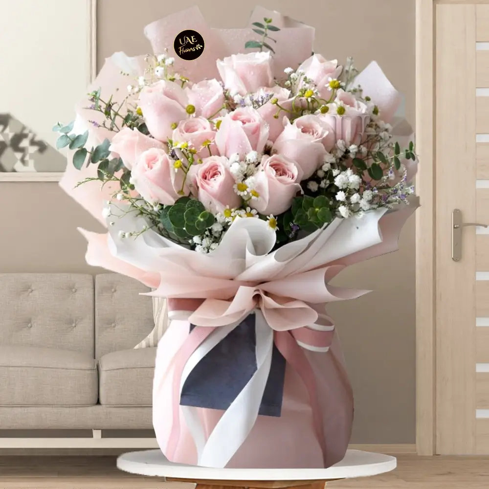 Bouquet of 12 stems of pink roses with fillers in a nice wrapping