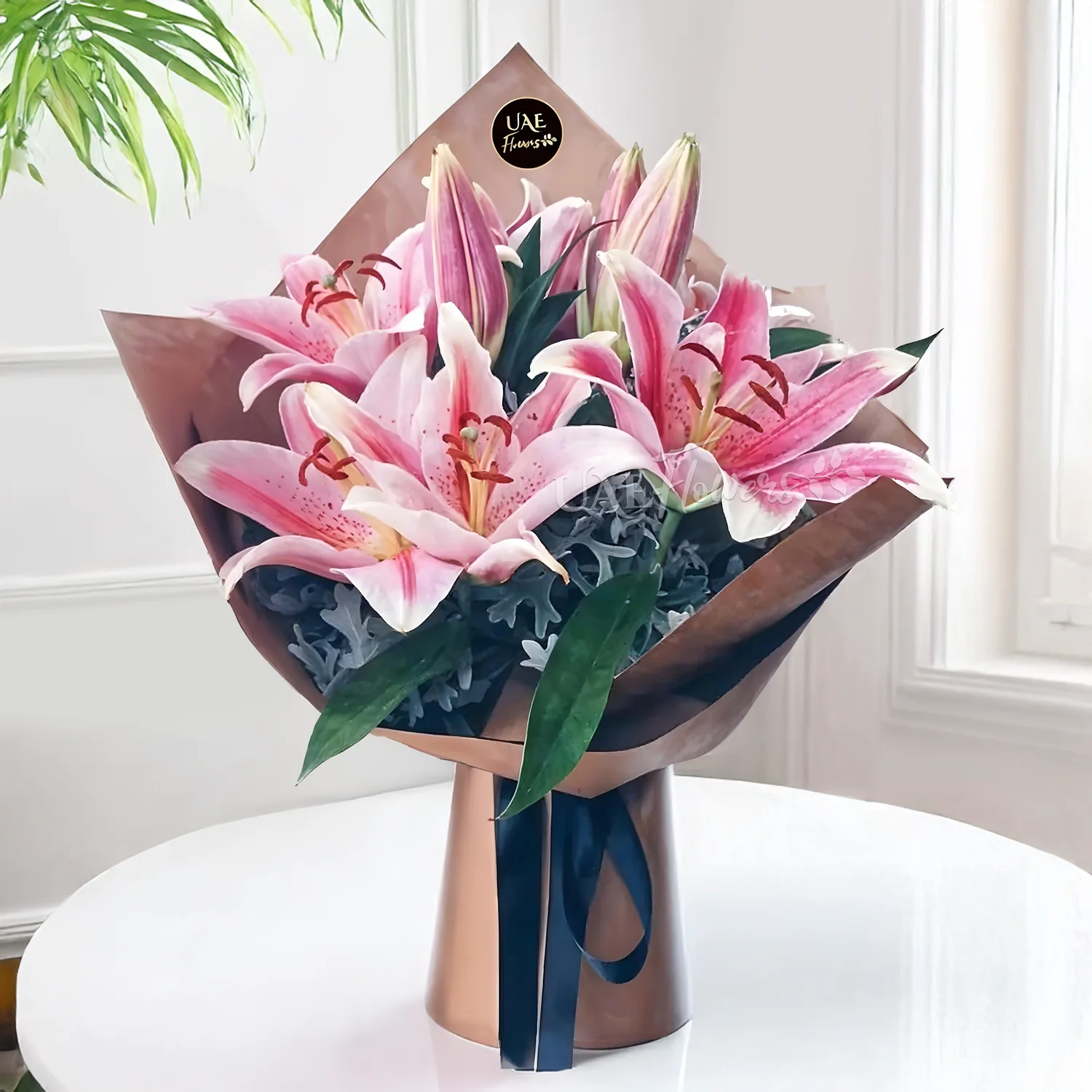 Bouquet of 3 stems of pink lilies and green fillers in a beautiful wrapping.