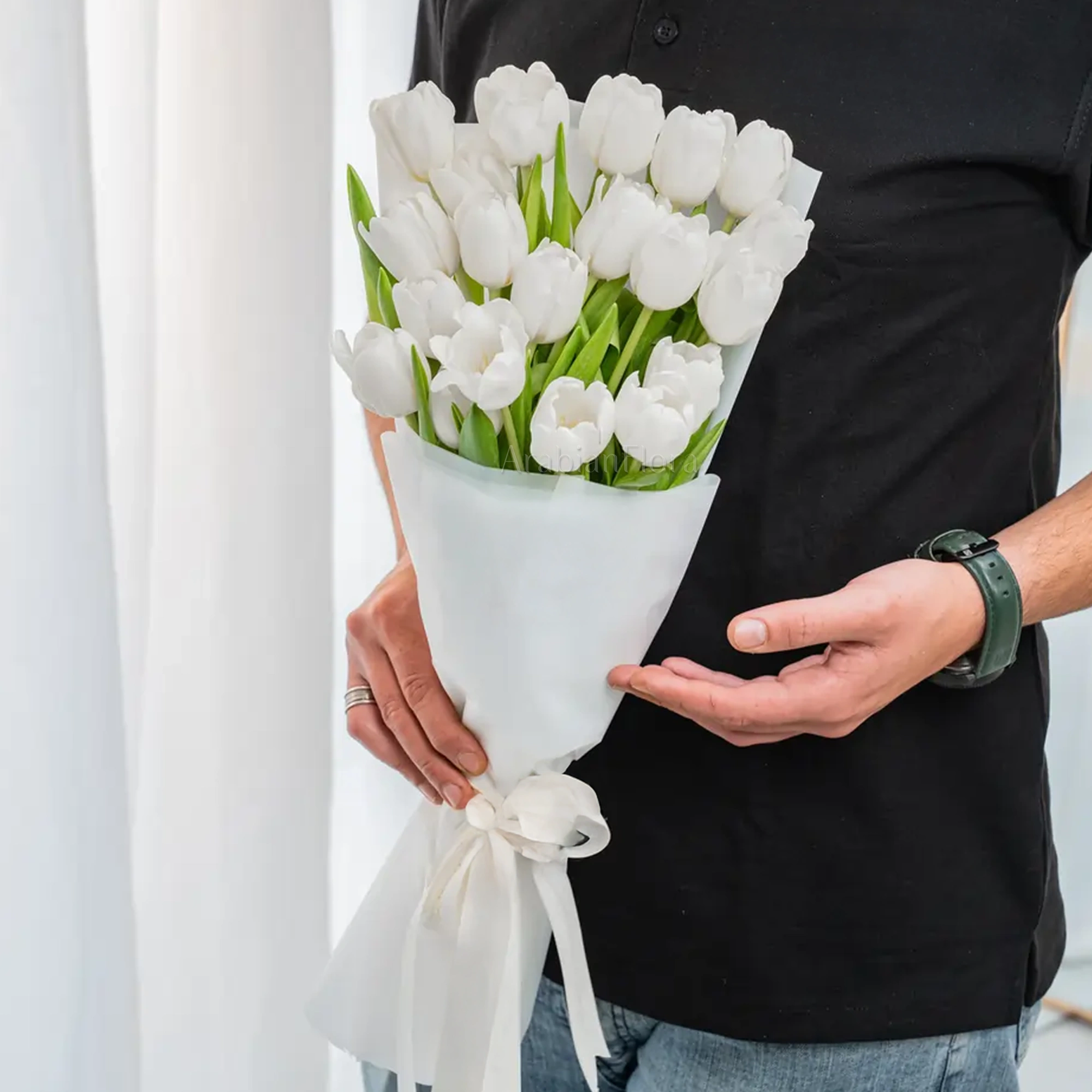 Bouquet of 20 white tulips in premium white wrapping tied with satin ribbon.