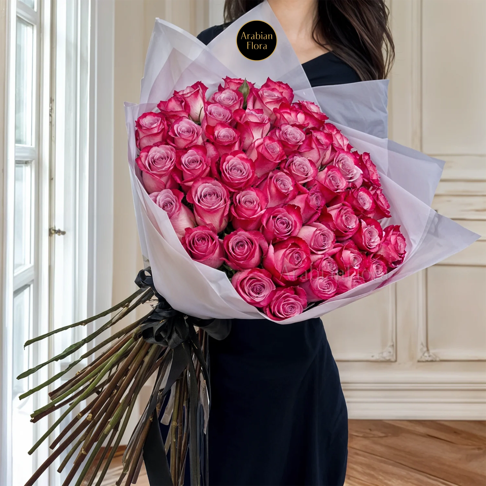 Bouquet of 40 purple roses in paper packing hand-tied with ribbons.