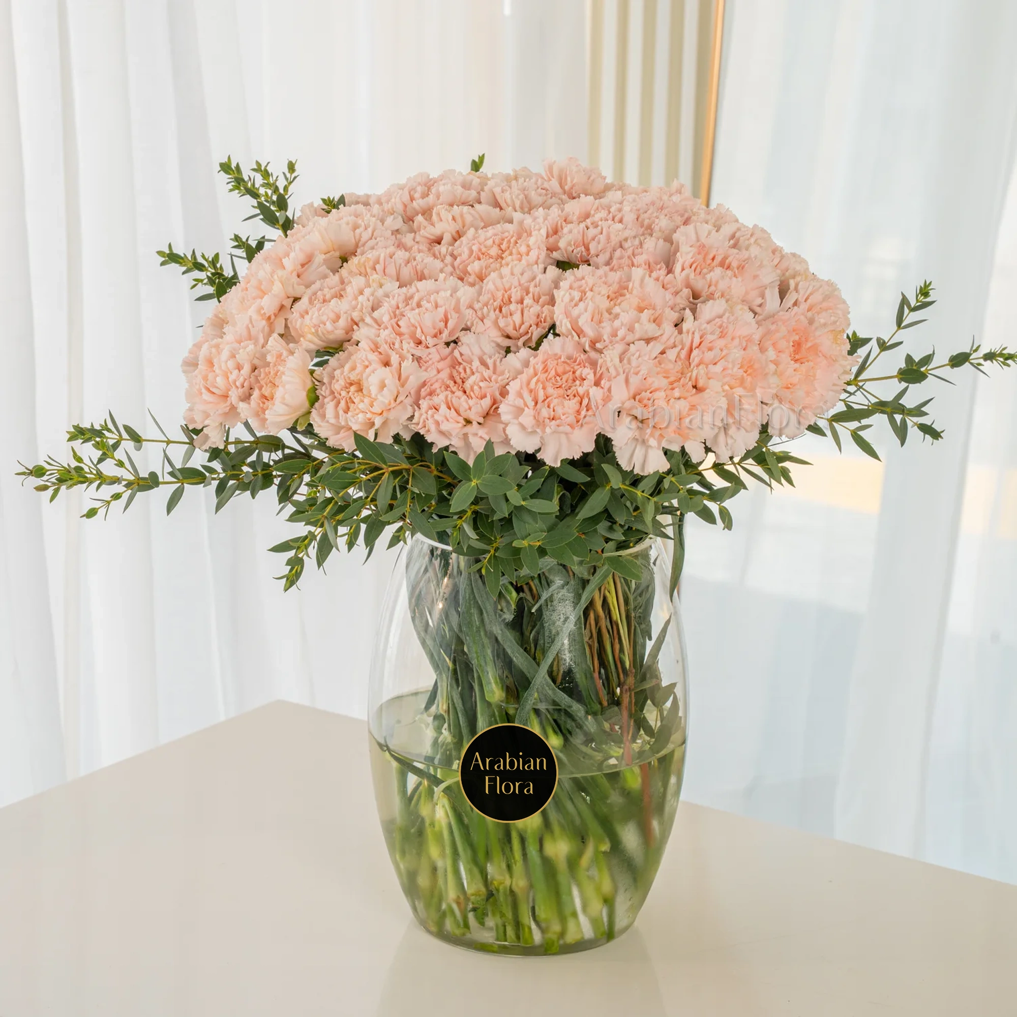 Glass vase of 40 Pink carnations with fillers