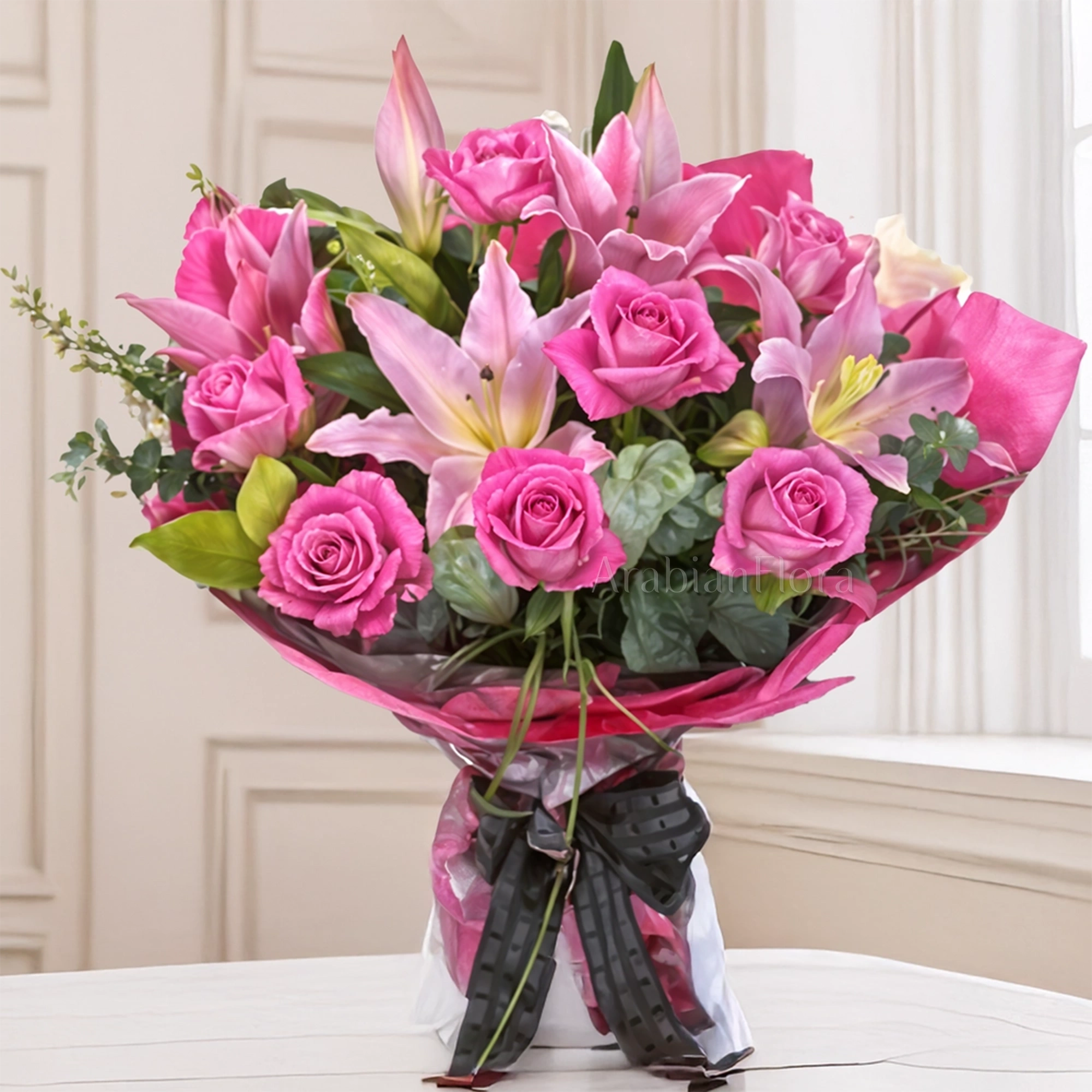 Bouquet of 2 Pink Lilies & 8 Stems of Pink Roses with greens in nice pink wrapping paper