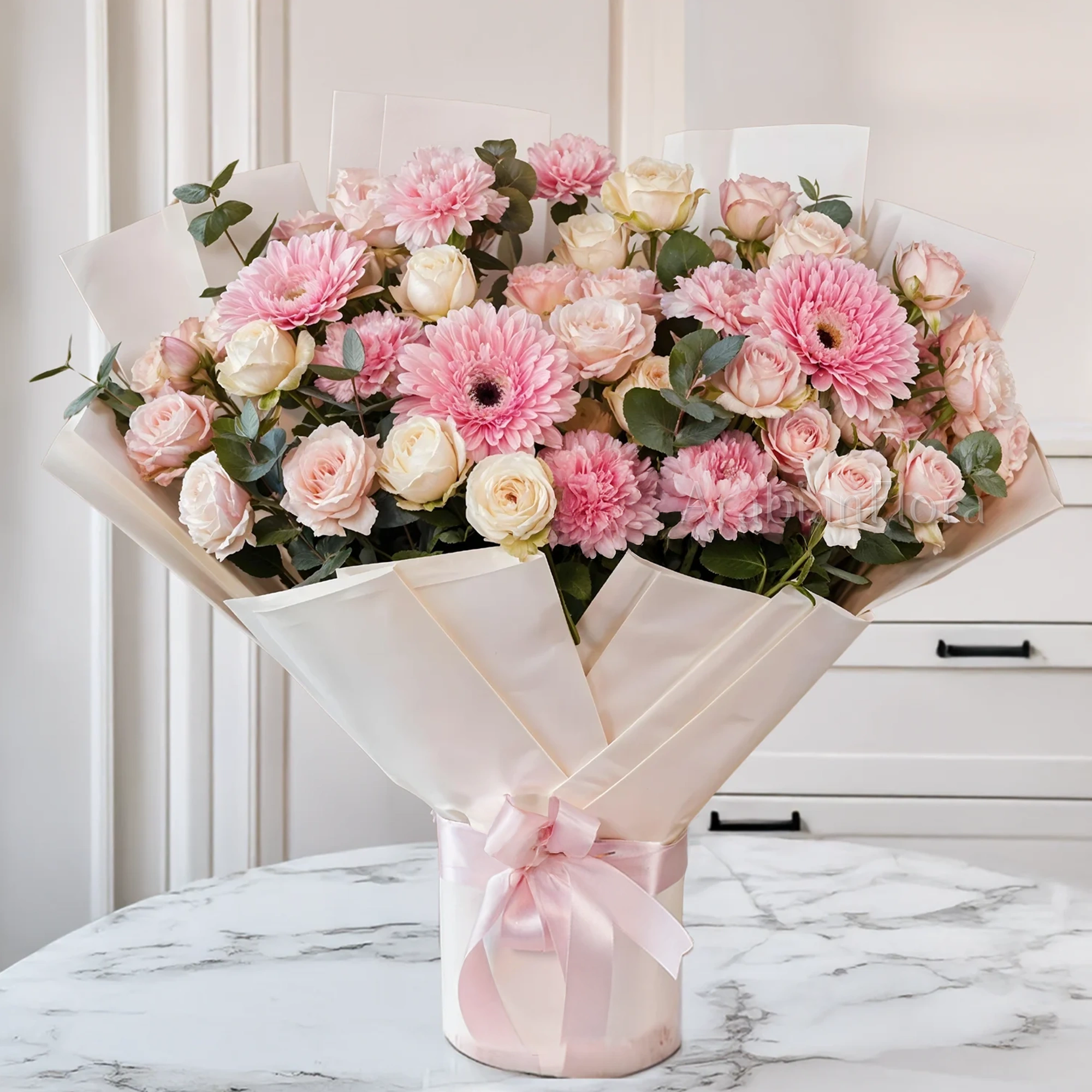 Bouquet of 4 pink gerberas, 6 pink carnations, 6 pink spray roses and 6 peach spray roses with green fillers tied with ribbons.