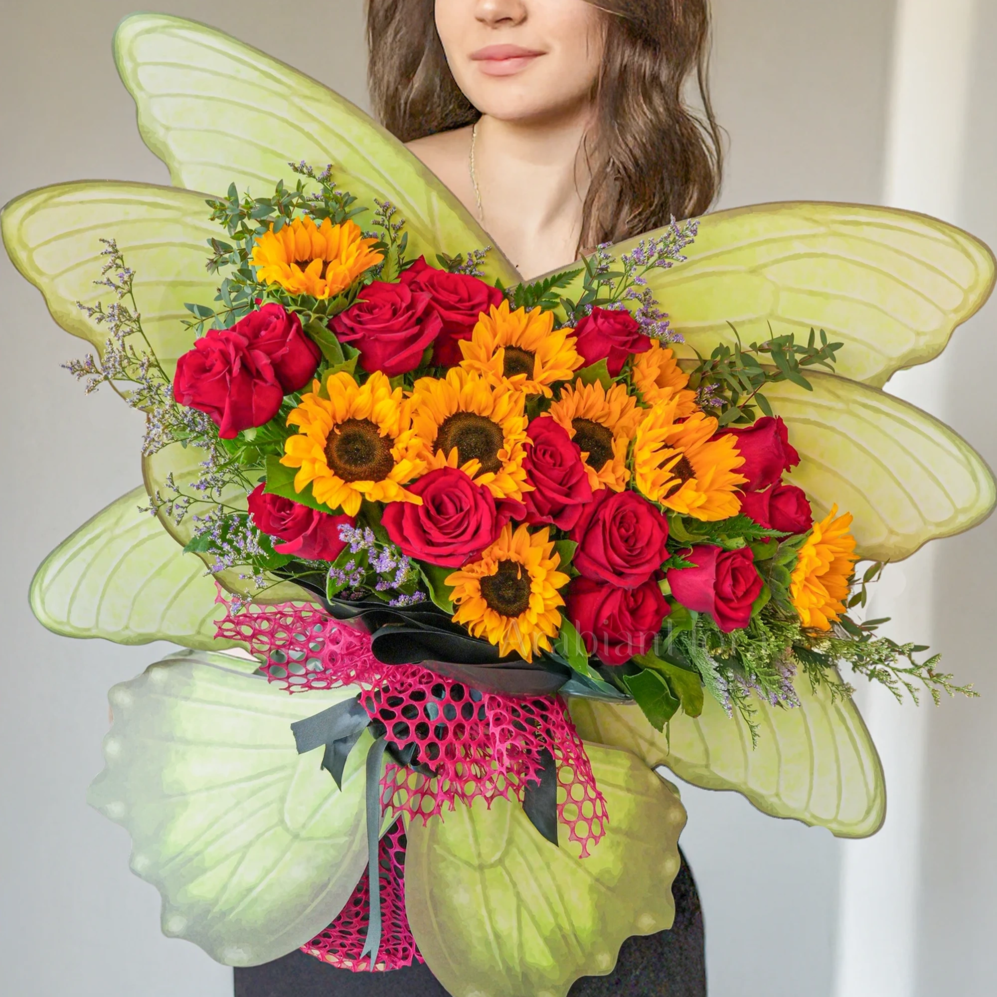Butterfly bouquet of 10 sunflowers and 12 red roses with limonium & green fillers tied with ribbons.