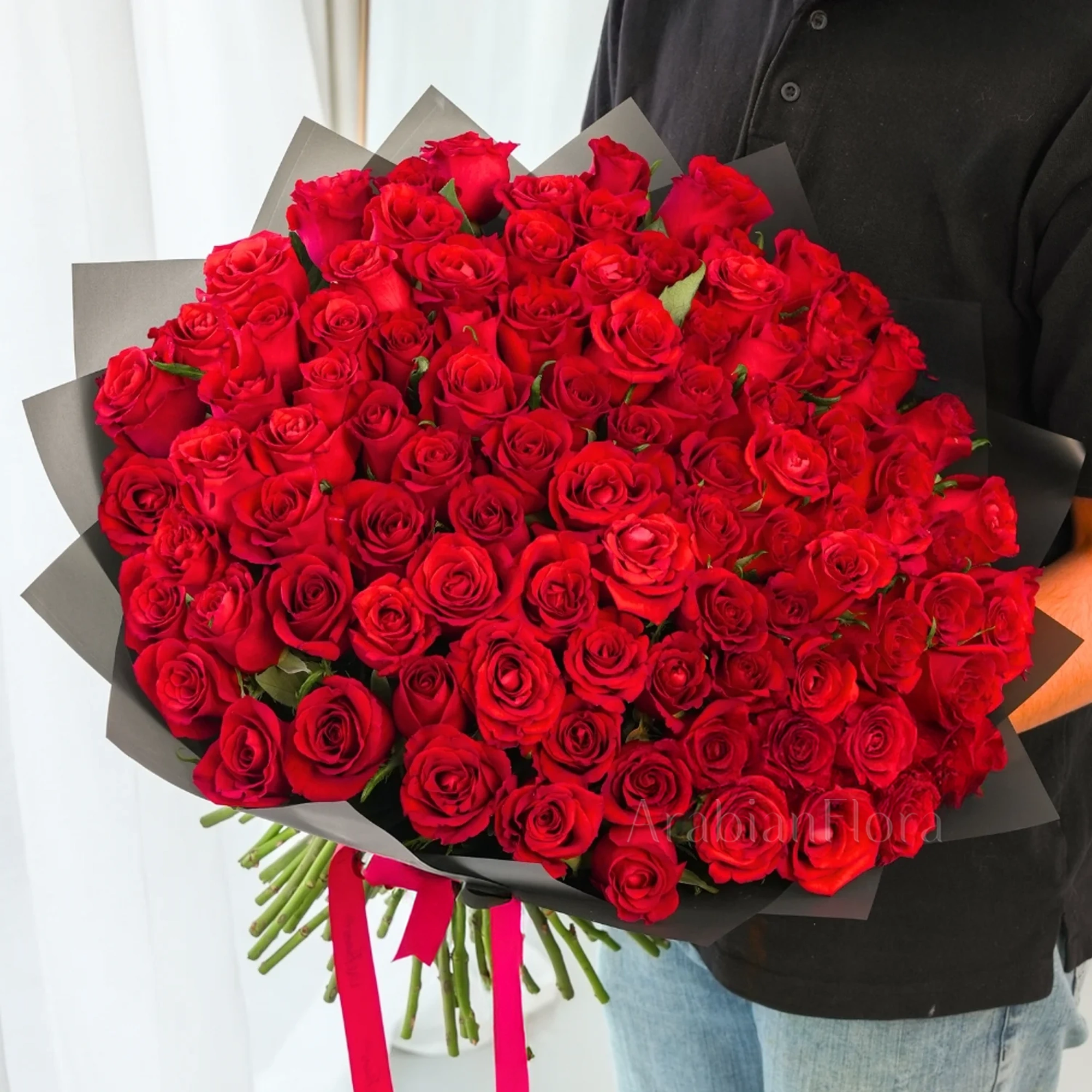 Bouquet of 100 Red Roses hand-tied with a red ribbon