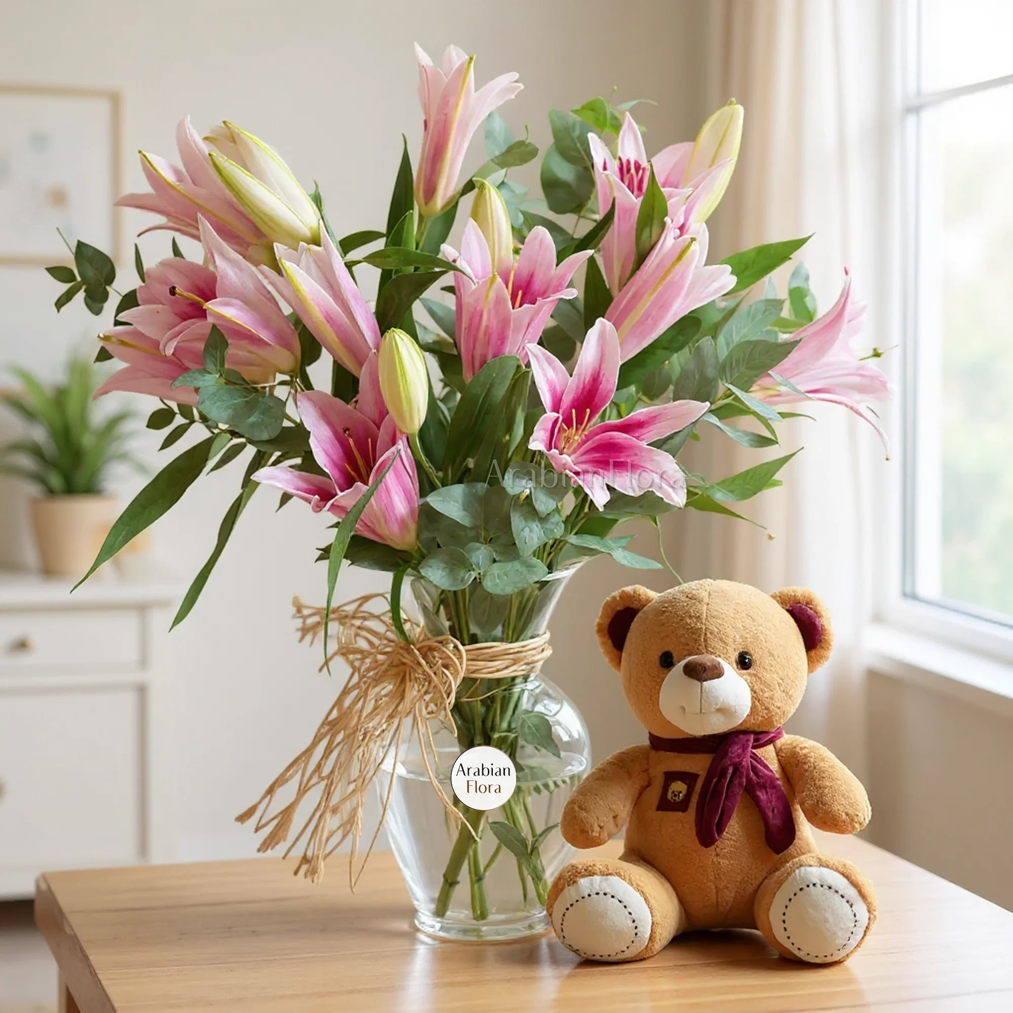 A vase of 5 pink lilies with a small teddy bear