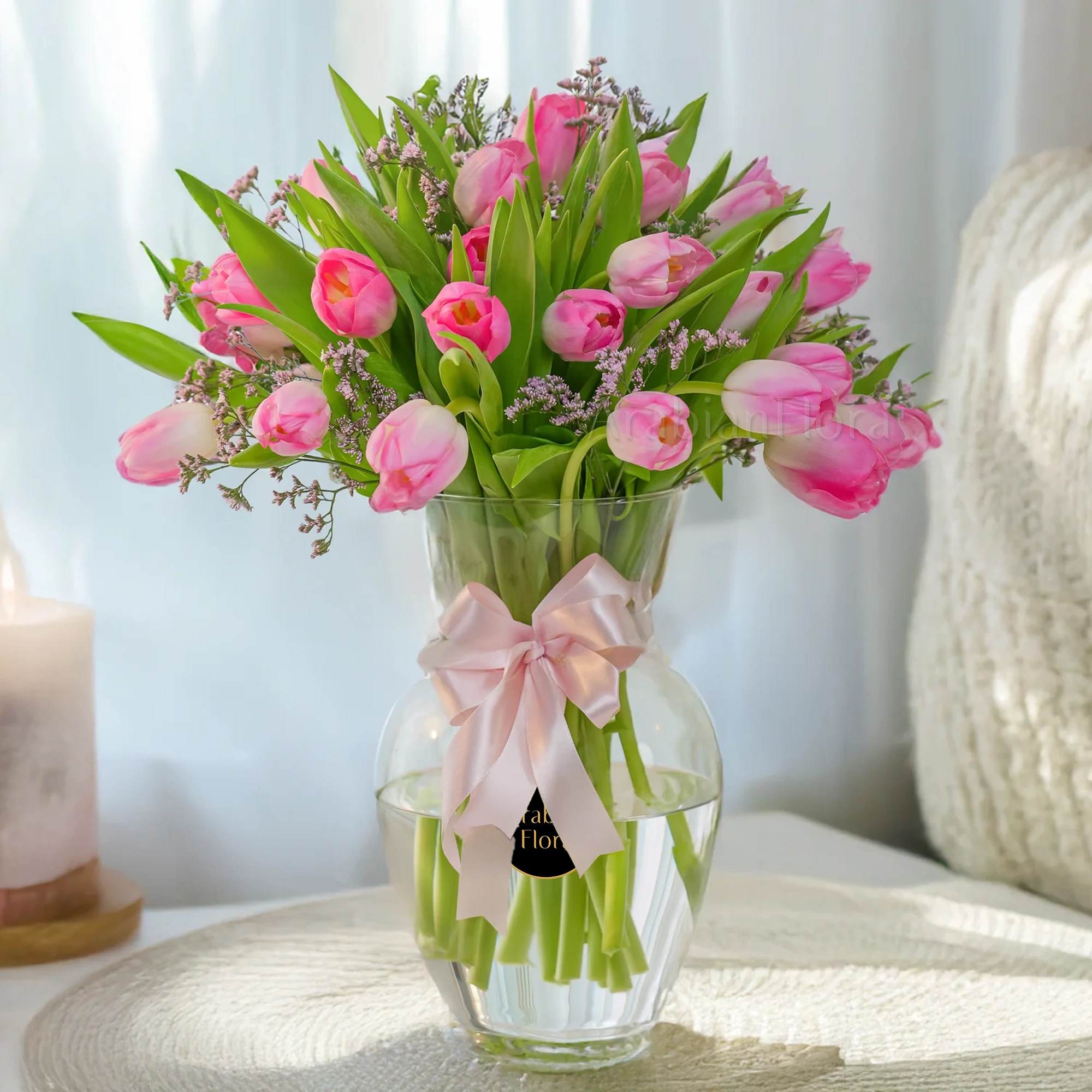 20 Pink Tulips Vase Arrangement with Limonium and a pink ribbon.