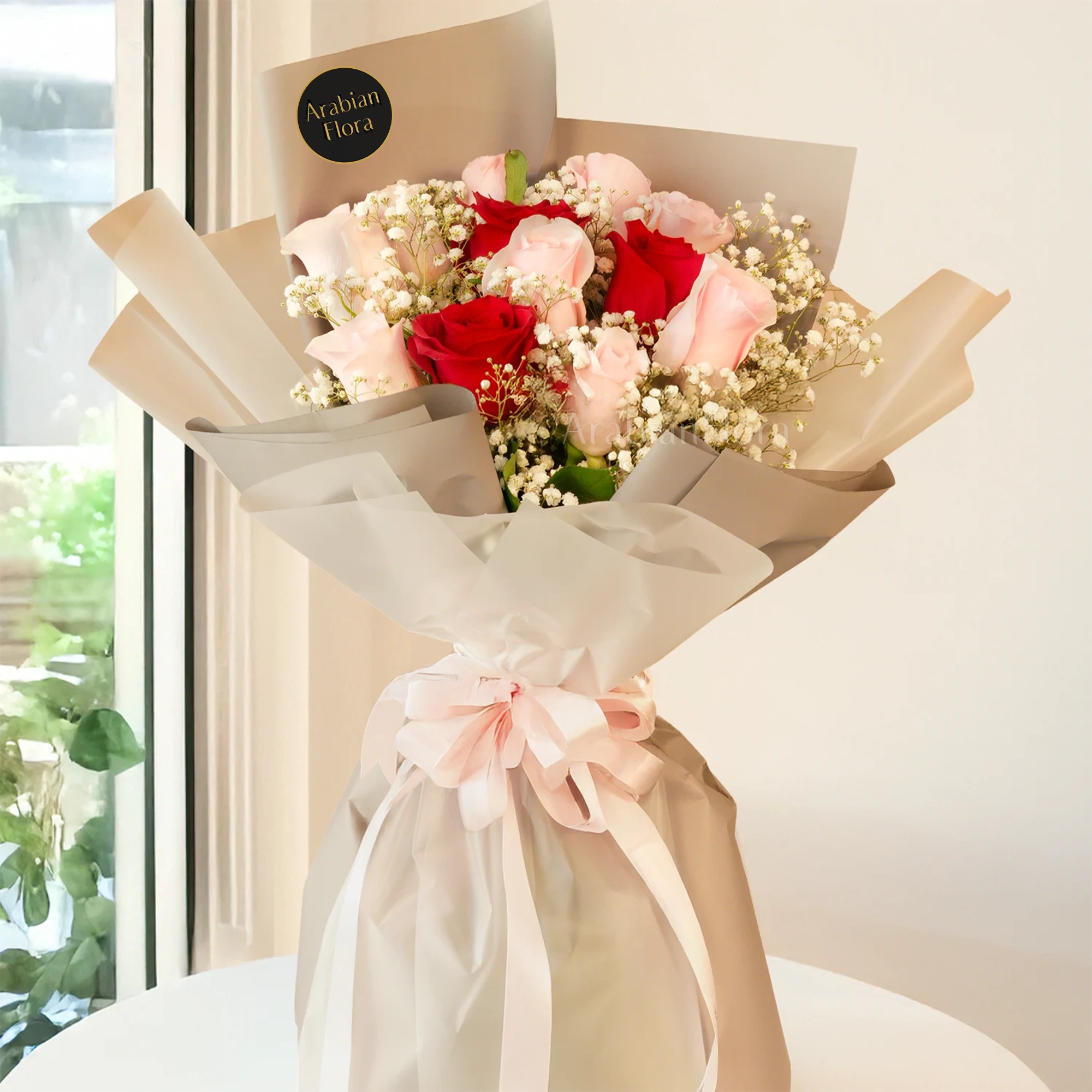 Bouquet, pink roses, red roses with baby's breath fillers in paper packing tied with ribbons.