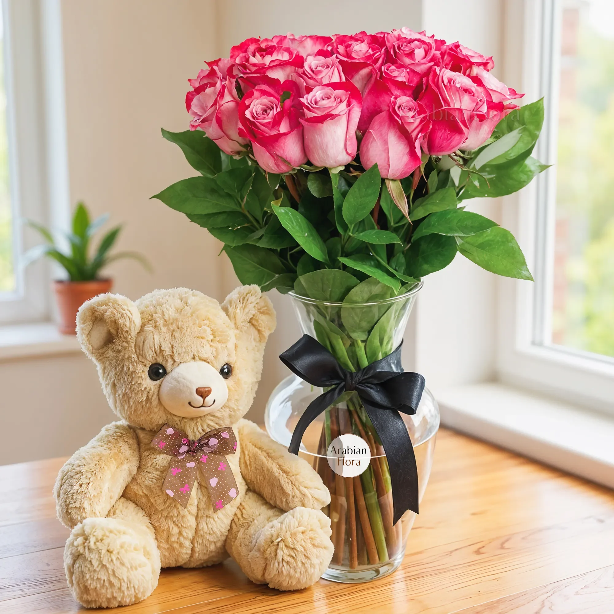 20 purple roses with green fillers in a glass vase and a small brown teddy bear.