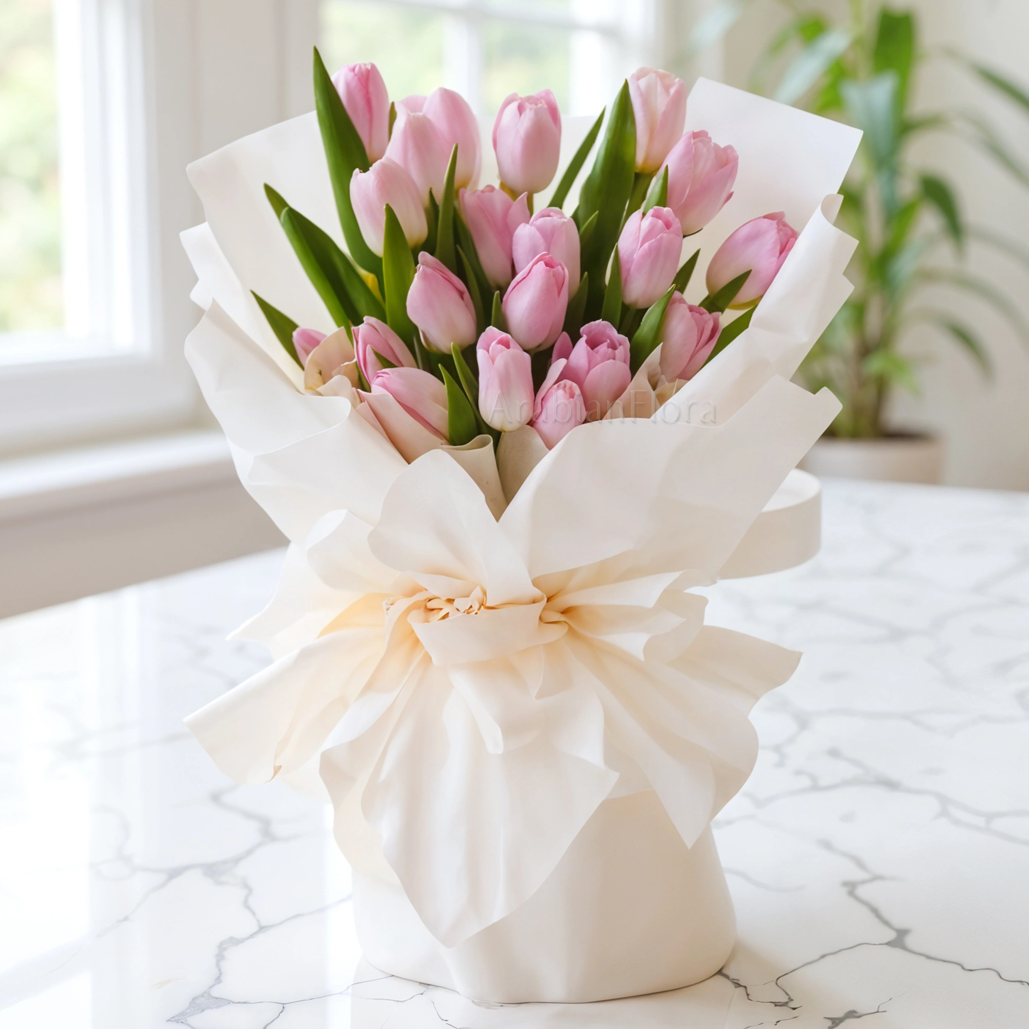 Bouquet of 20 stems of pink tulips with fillers beautifully wrapped in a paper packing with ribbons