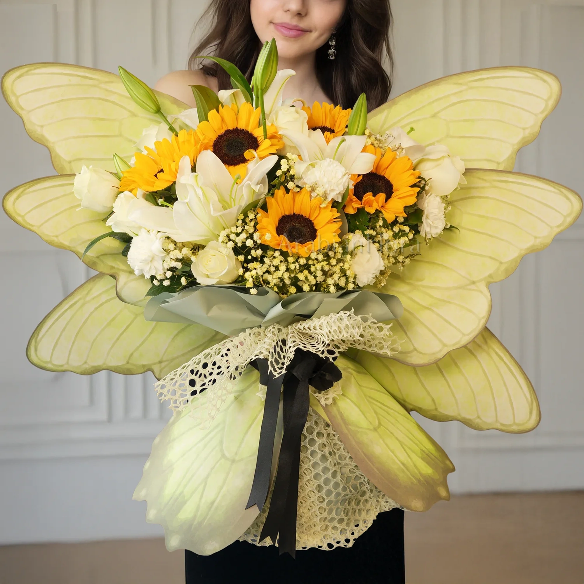 Butterfly bouquet of 5 sunflowers, 5 white carnations, 5 white roses and 2 white lilies with baby's breath and tied with ribbons.