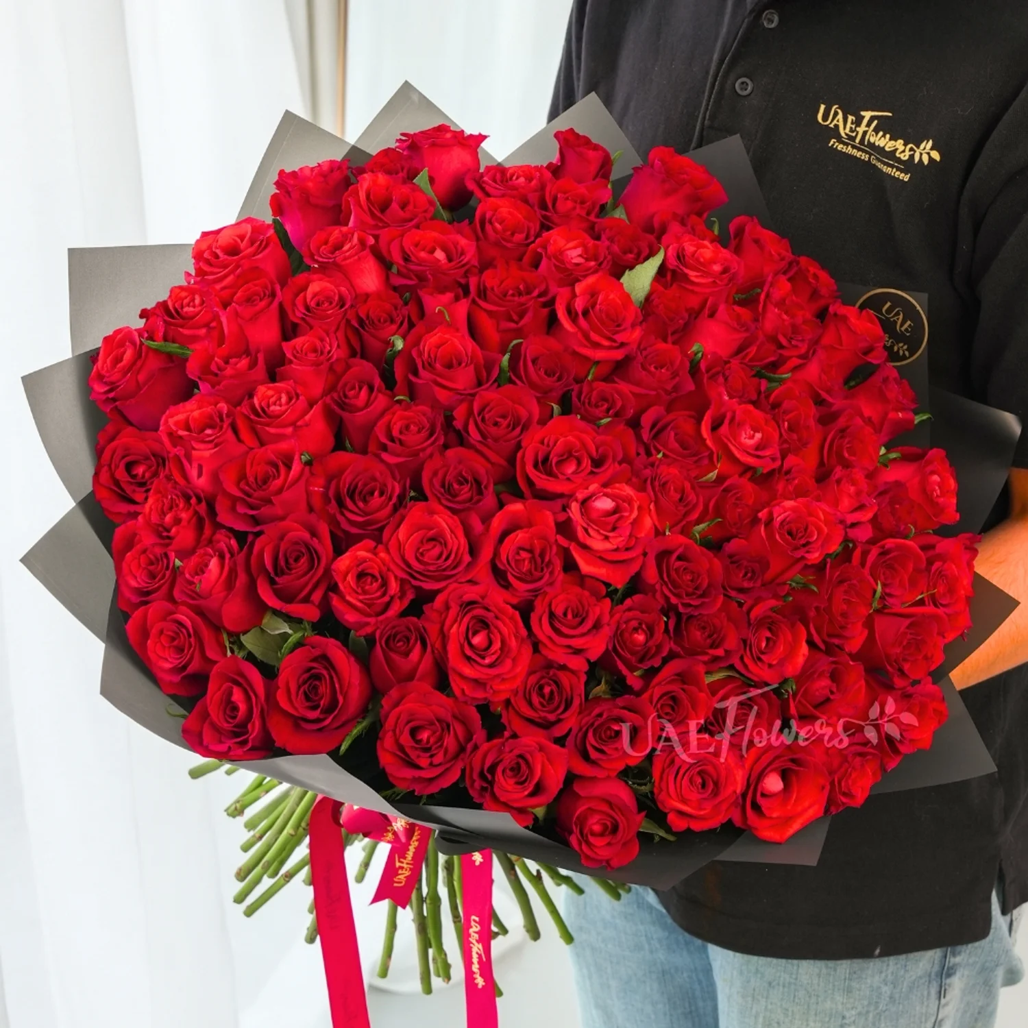 Bouquet of 100 Red Roses hand-tied with a red ribbon