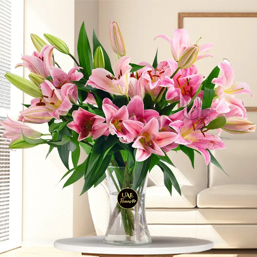 10 stems of Pink Lilies with Greens & Fillers in a Glass Vase.