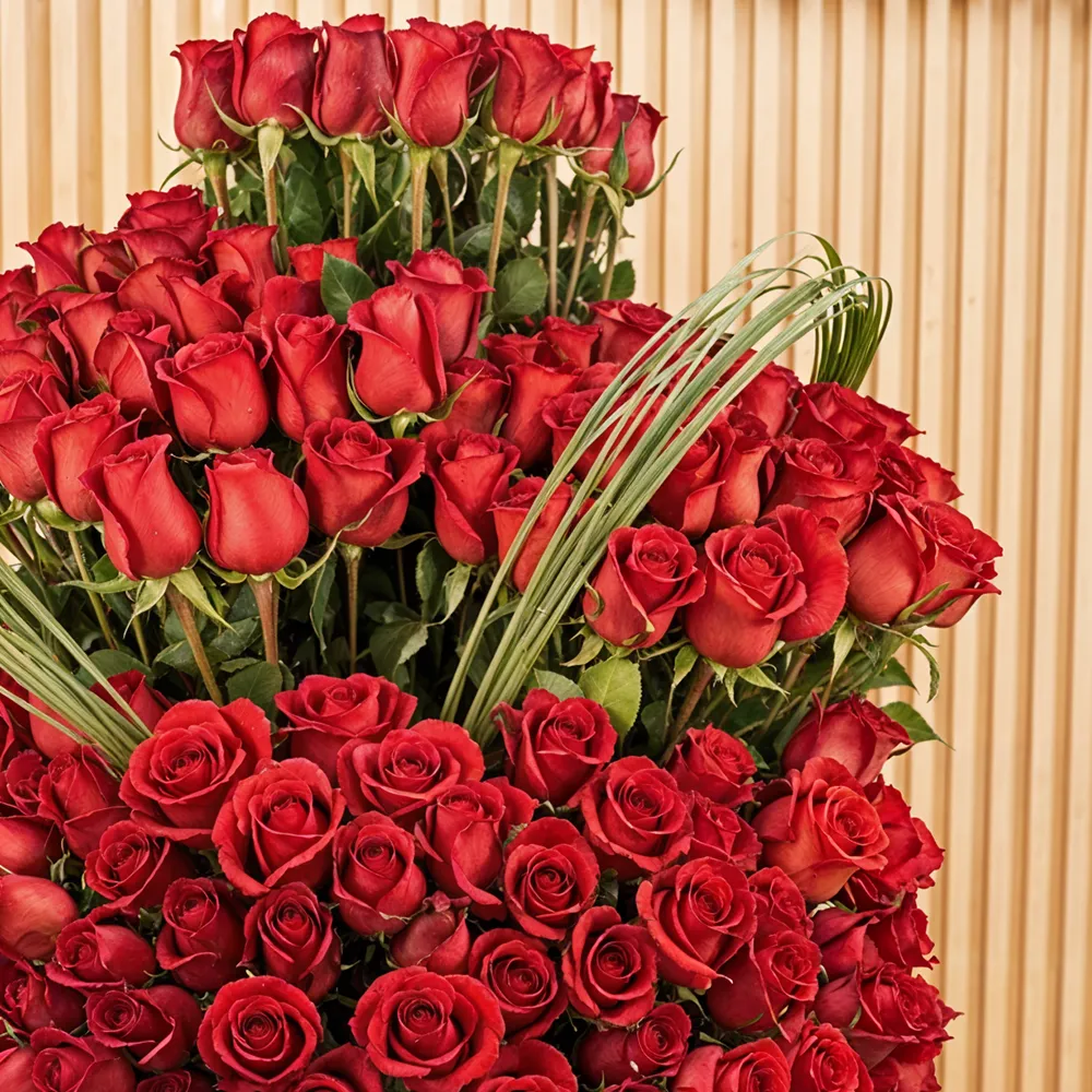 200 red roses with green fillers in a glass vase