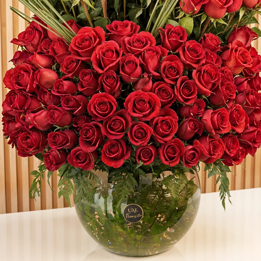200 red roses with green fillers in a glass vase