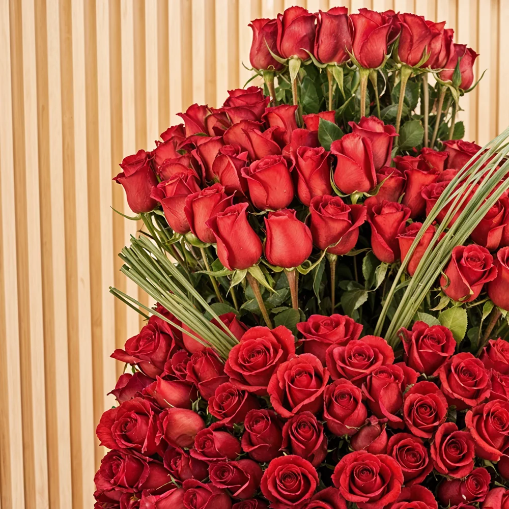 200 red roses with green fillers in a glass vase