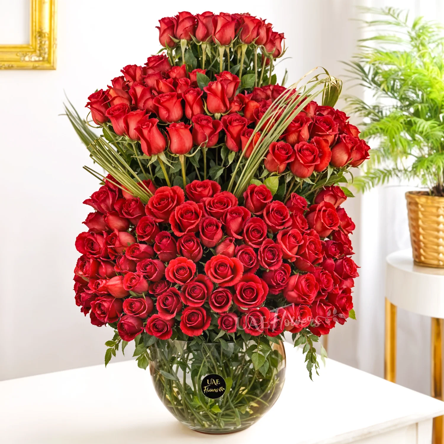 200 red roses with green fillers in a glass vase