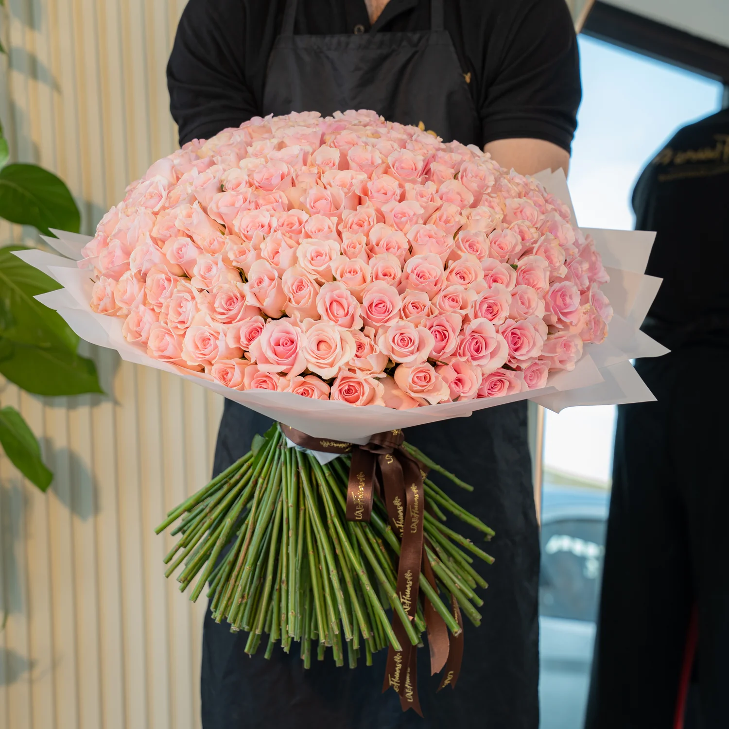A handtied bouquet of 200 pink roses wrapped in pink.