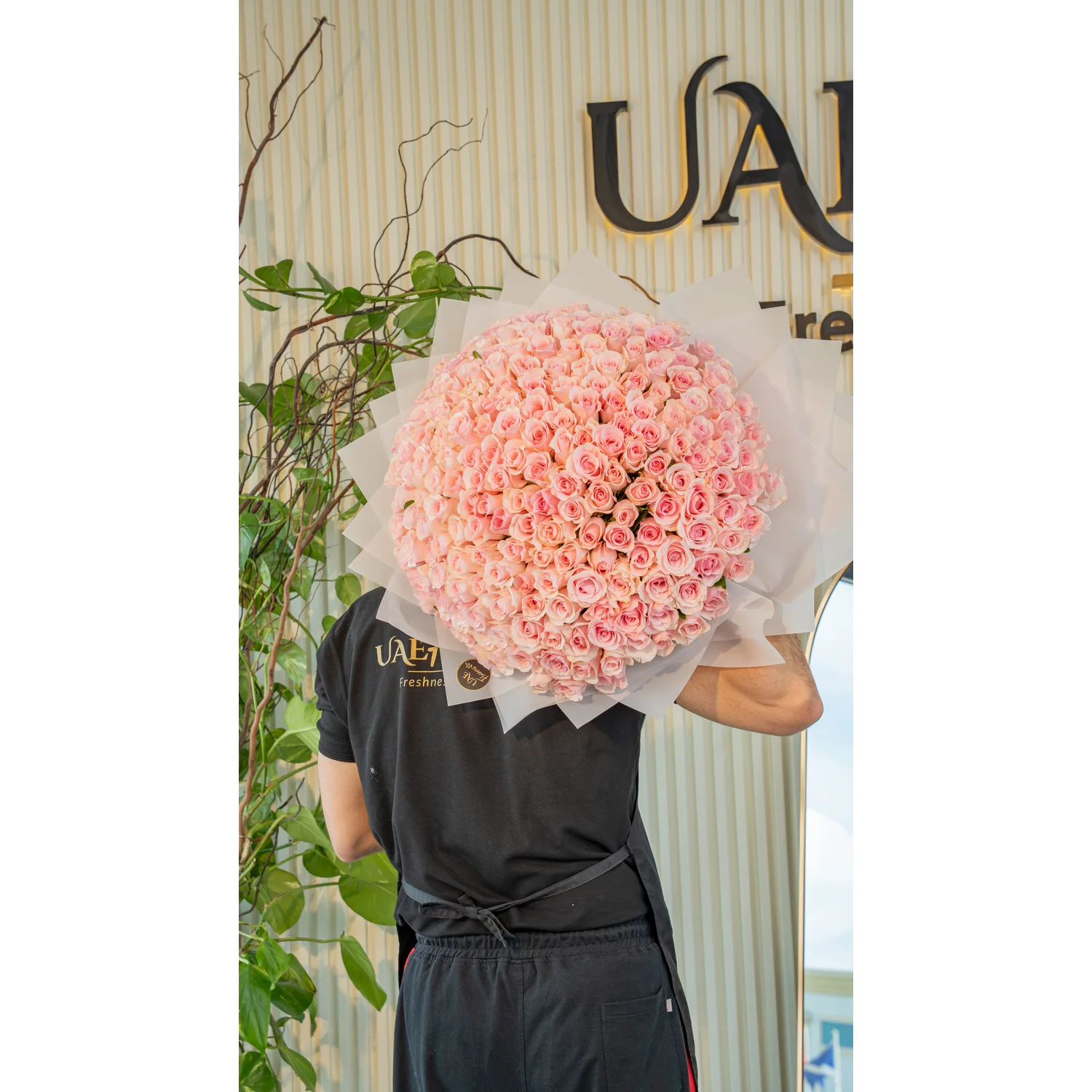 A handtied bouquet of 200 pink roses wrapped in pink.