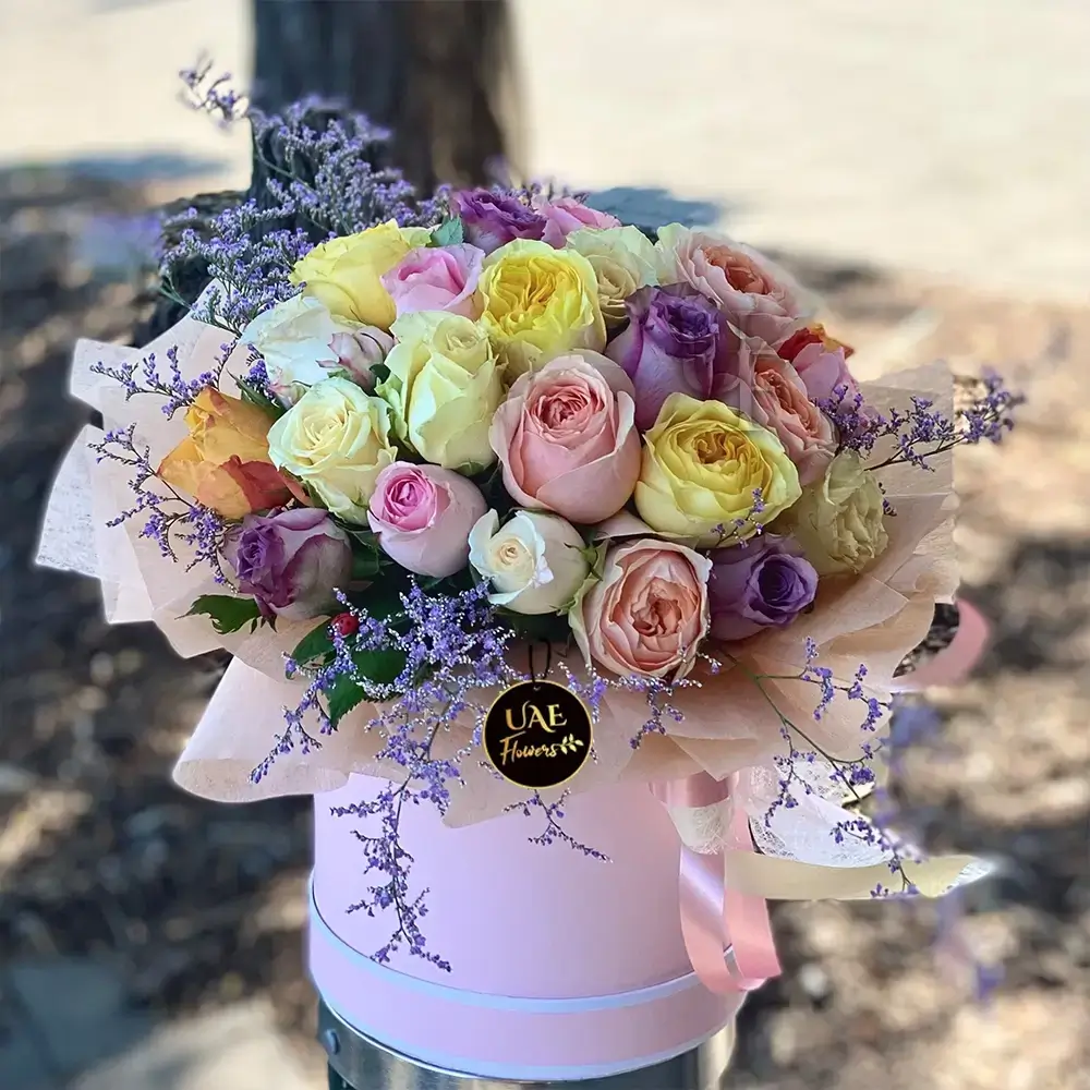 20 stems of mix color roses with fillers in a round box.
