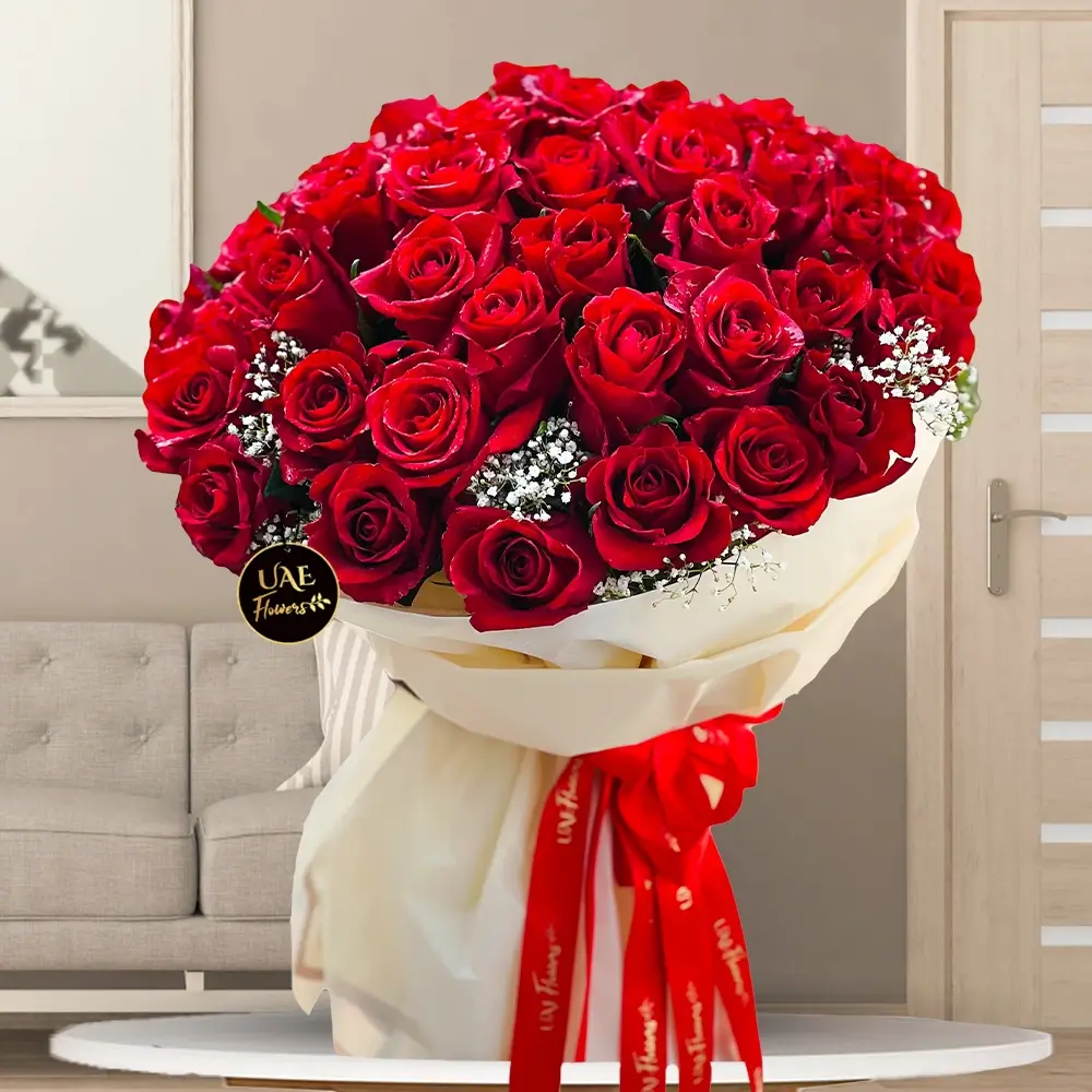 Bouquet of 40 stems of red roses with fillers beautifully wrapped in paper packing and ribbons