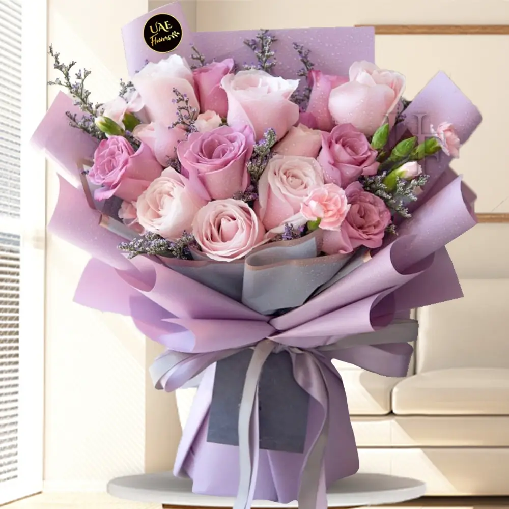 Bouquet of 9 light Pink Roses, 6 Purple Roses & 3 light Pink Carnations with fillers in a nice wrapping