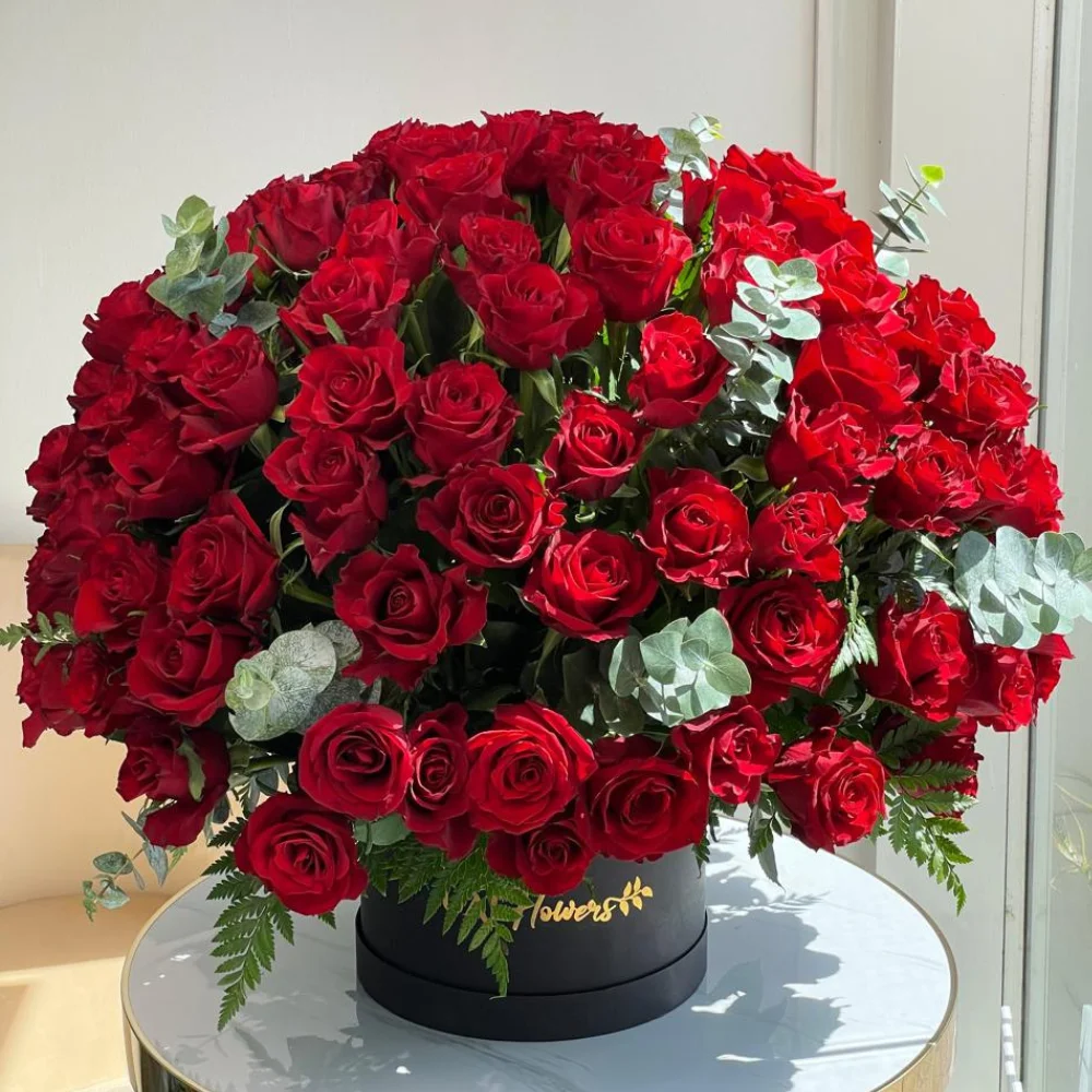 200 stems of red roses with eucalyptus leaf in a black box.