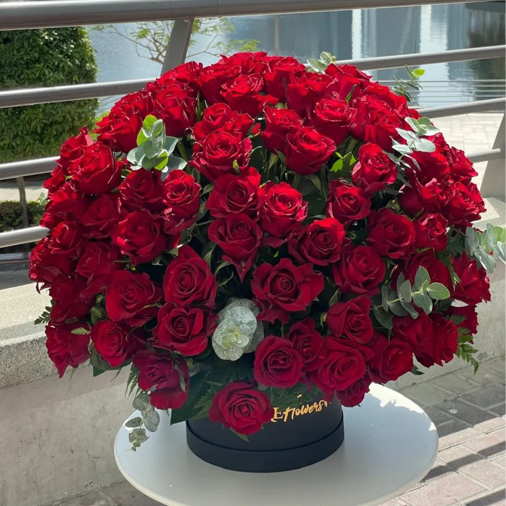 200 stems of red roses with eucalyptus leaf in a black box.
