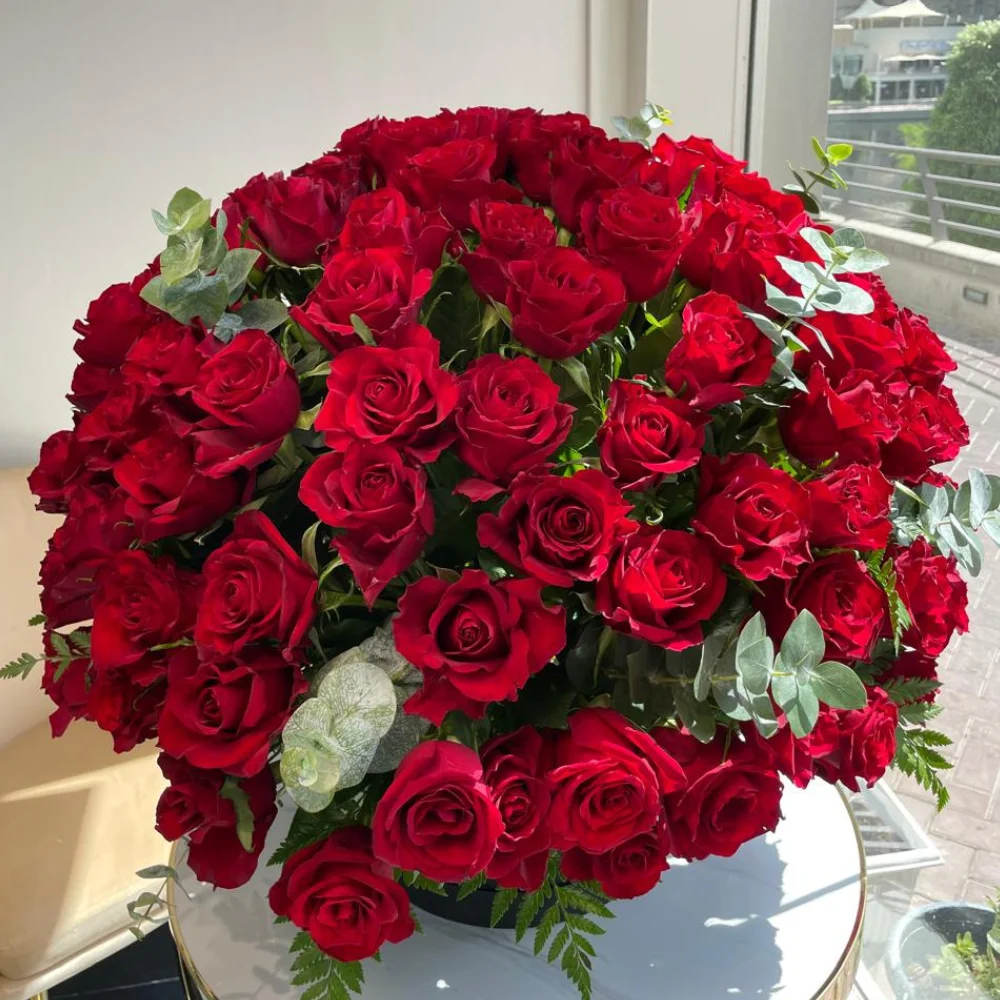 200 stems of red roses with eucalyptus leaf in a black box.