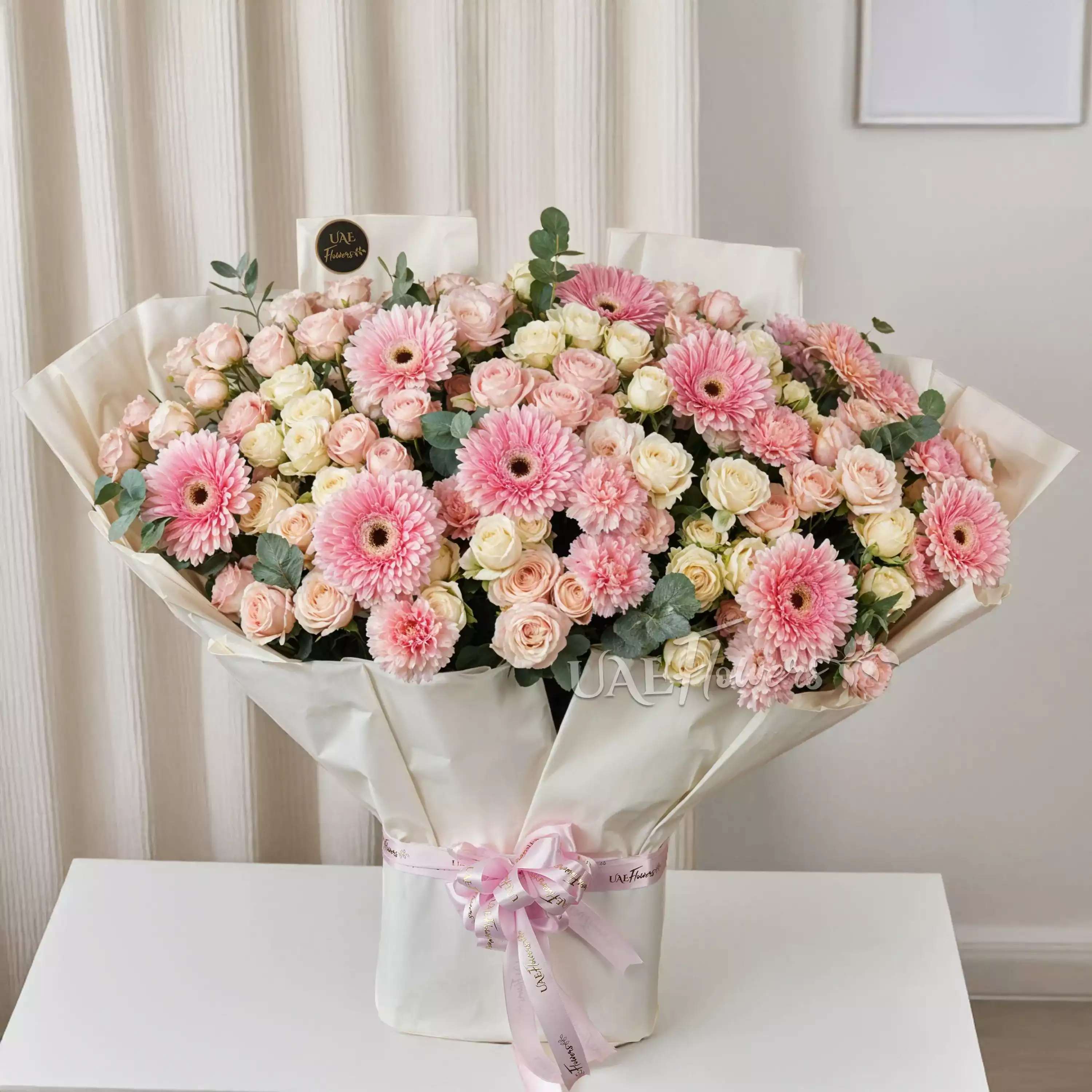 Bouquet of 20 pink & white spray roses, 10 pink gerberas and 10 pink carnations with green fillers tied with ribbons.