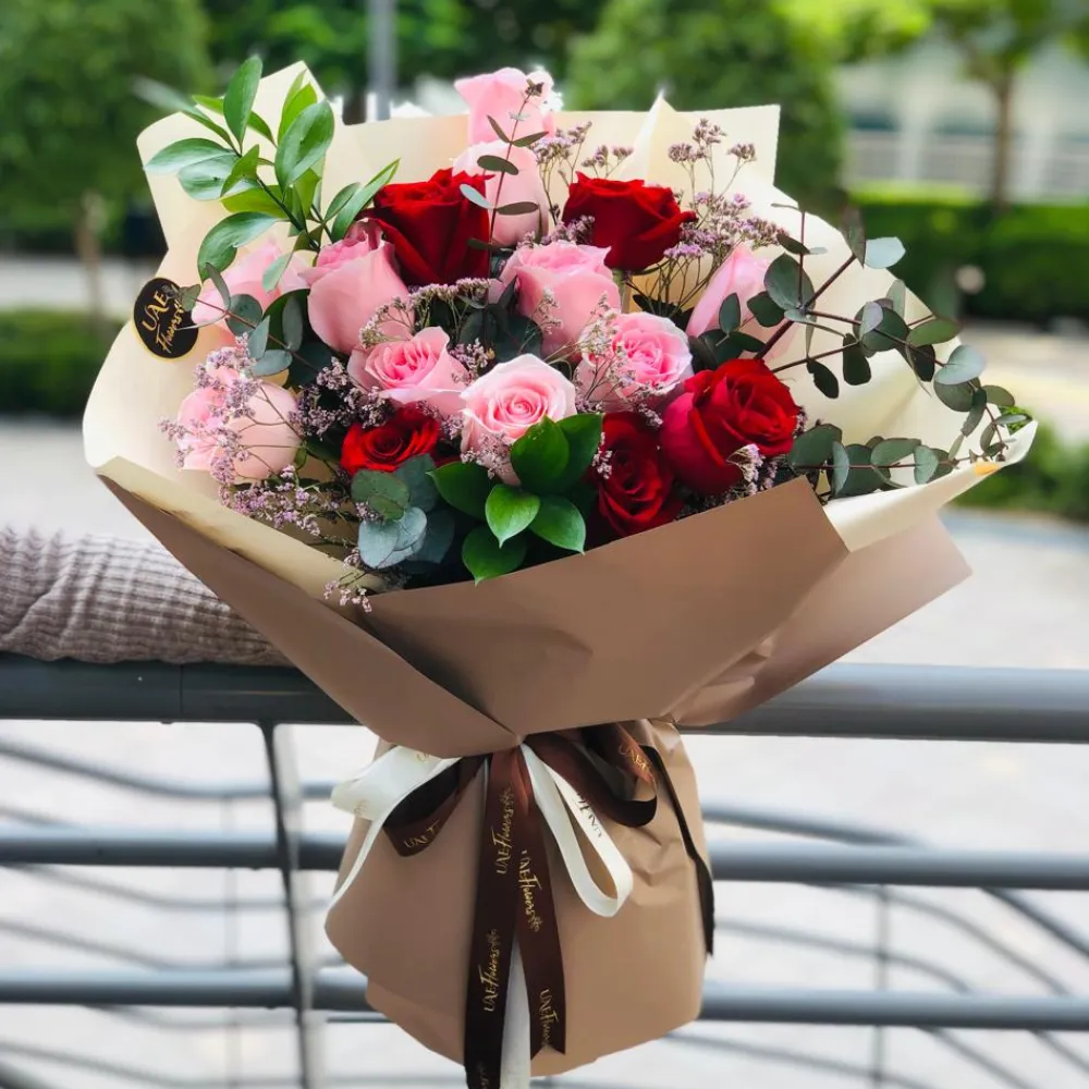 Bouquet of 6 stems of pink roses and 6 stems of red roses with eucalyptus leaf with green fillers in nice wrapping.