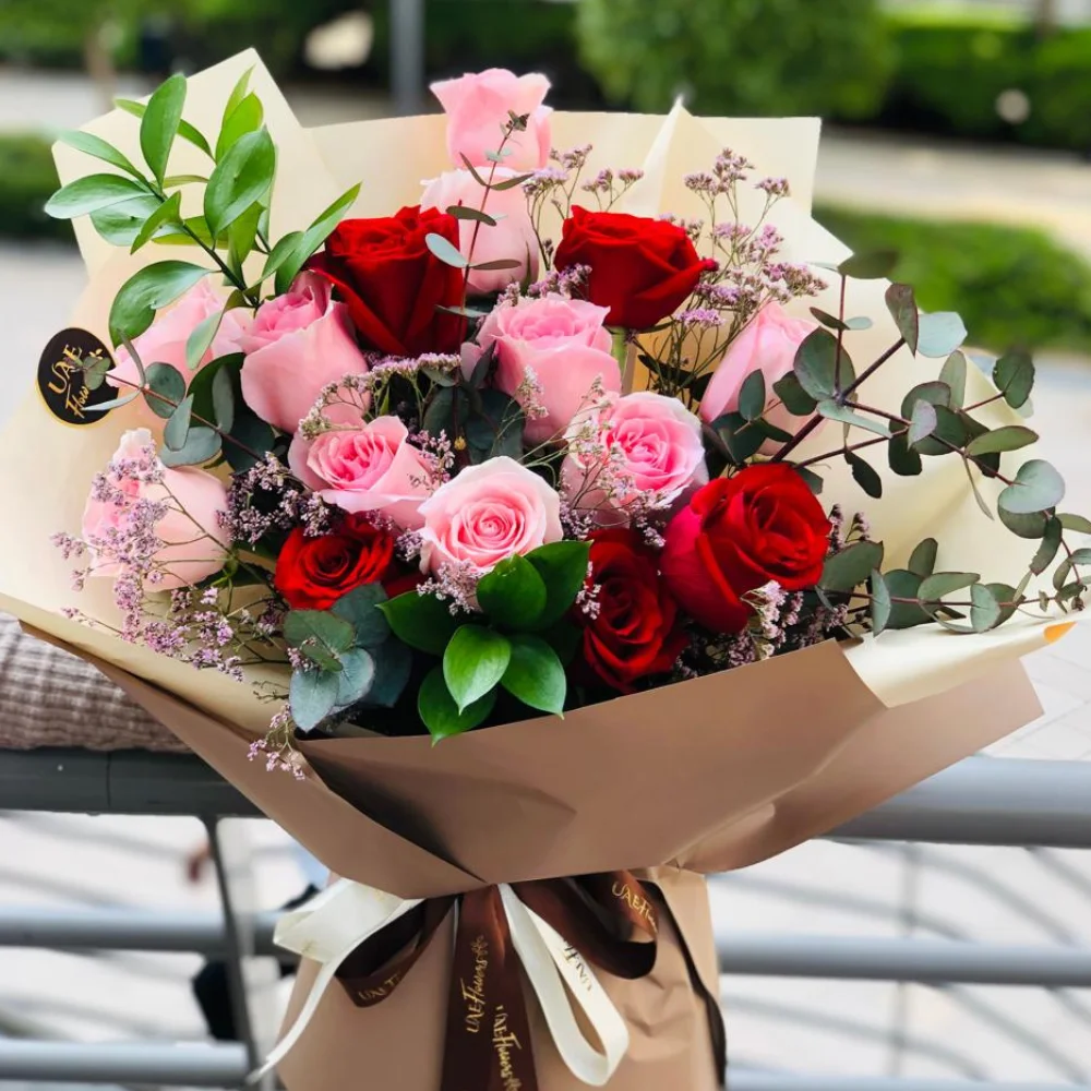 Bouquet of 6 stems of pink roses and 6 stems of red roses with eucalyptus leaf with green fillers in nice wrapping.