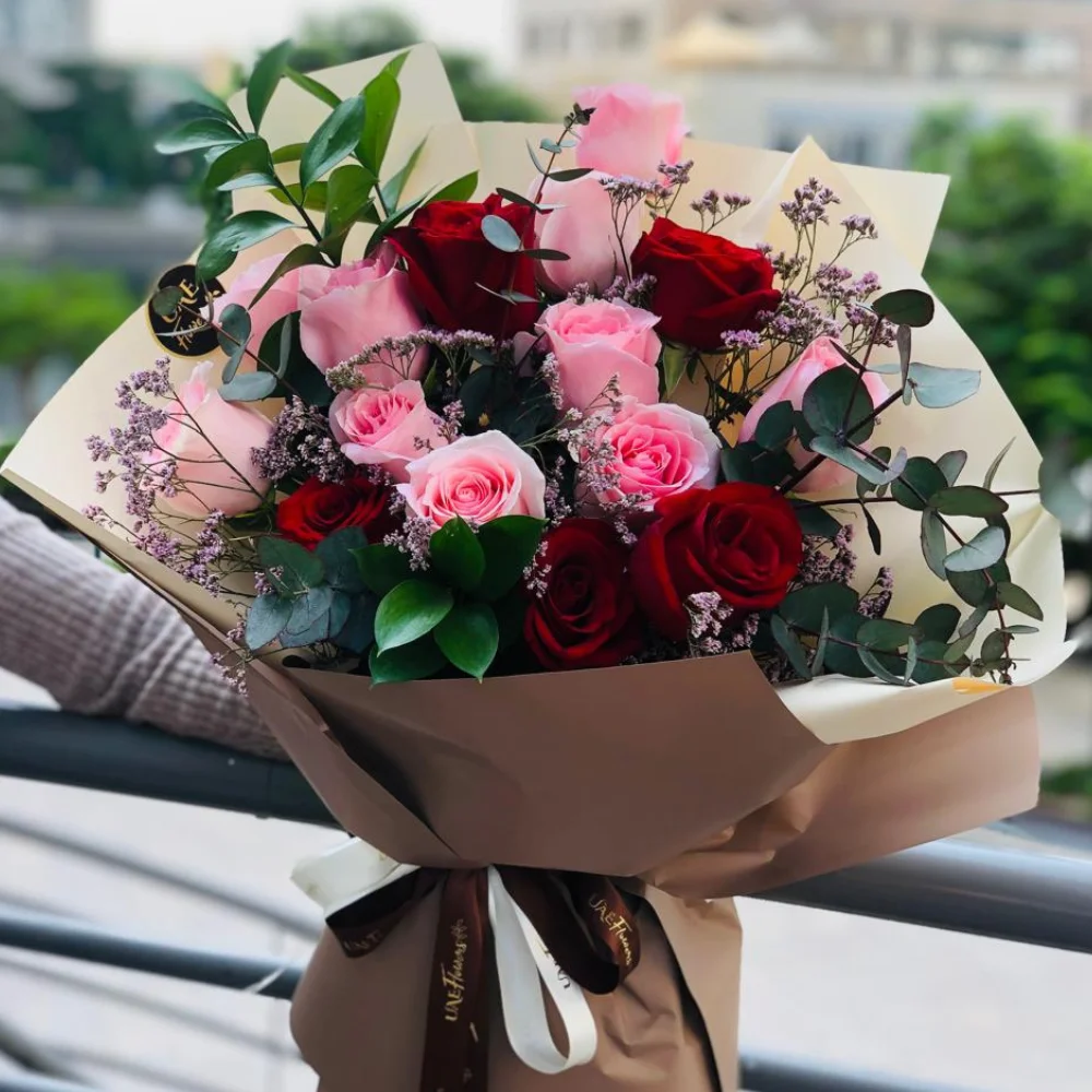 Bouquet of 6 stems of pink roses and 6 stems of red roses with eucalyptus leaf with green fillers in nice wrapping.