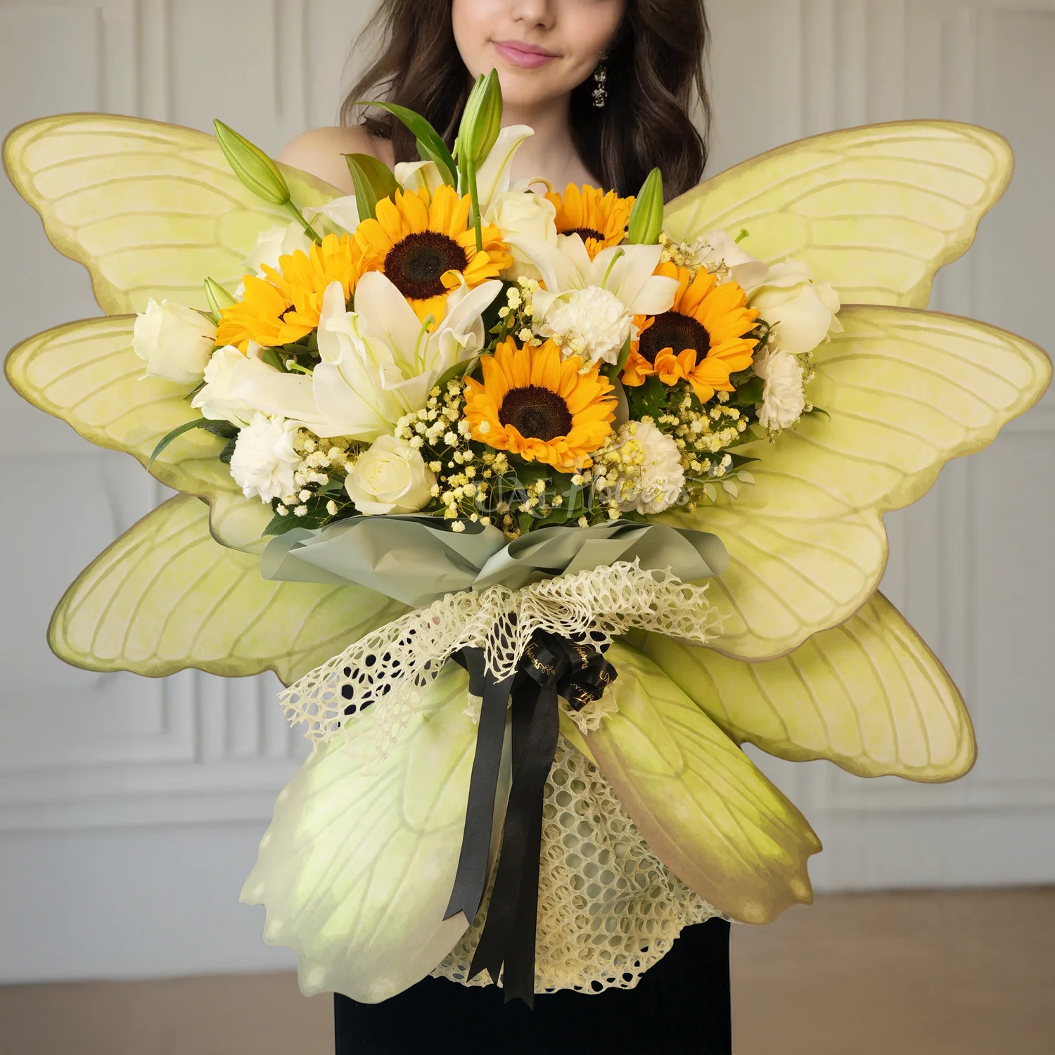 Butterfly bouquet of 5 sunflowers, 5 white carnations, 5 white roses and 2 white lilies with baby's breath and tied with ribbons.
