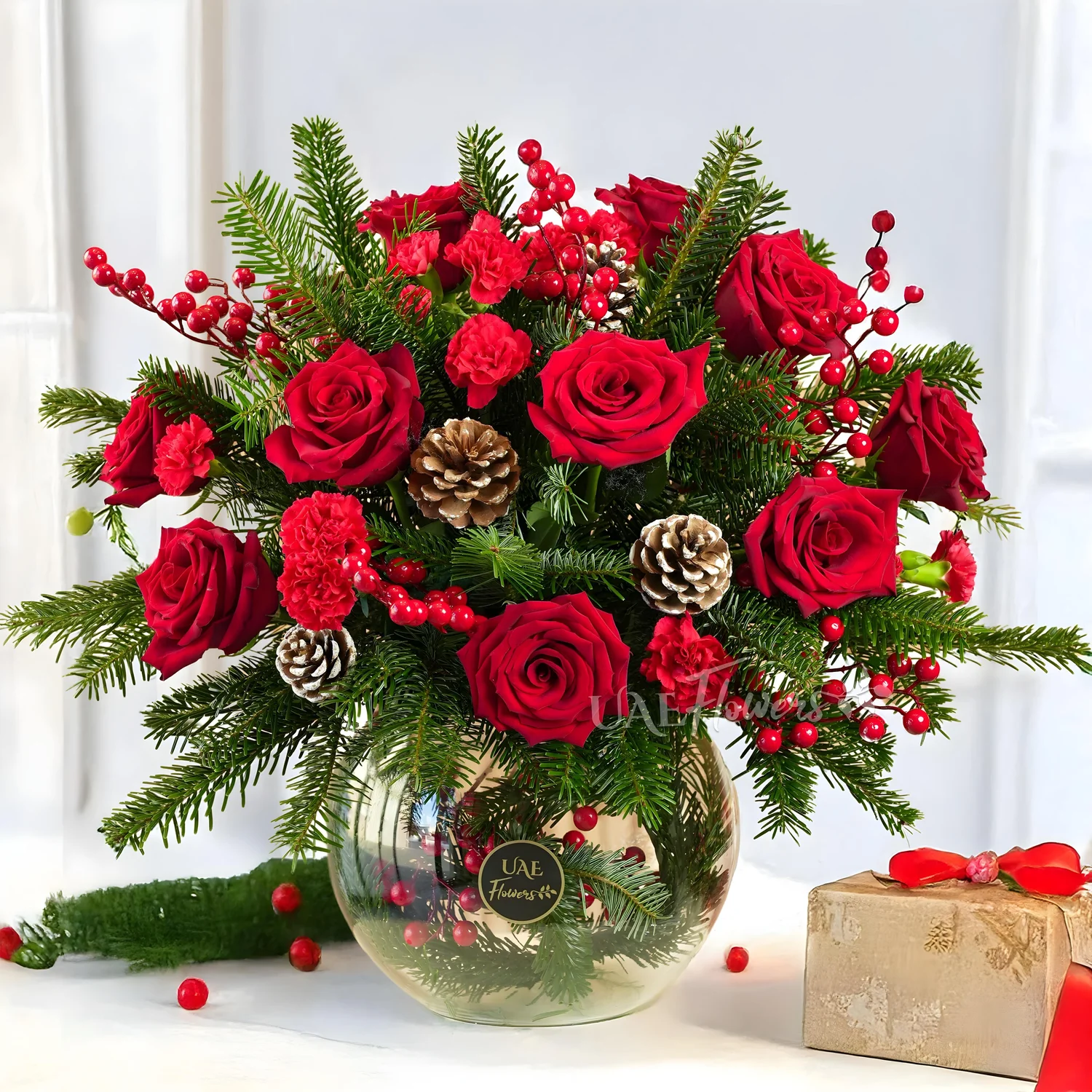 Glass Vase with 12 red roses, 10 red carnations, pinecones, hypericum and decorative Christmas fillers.