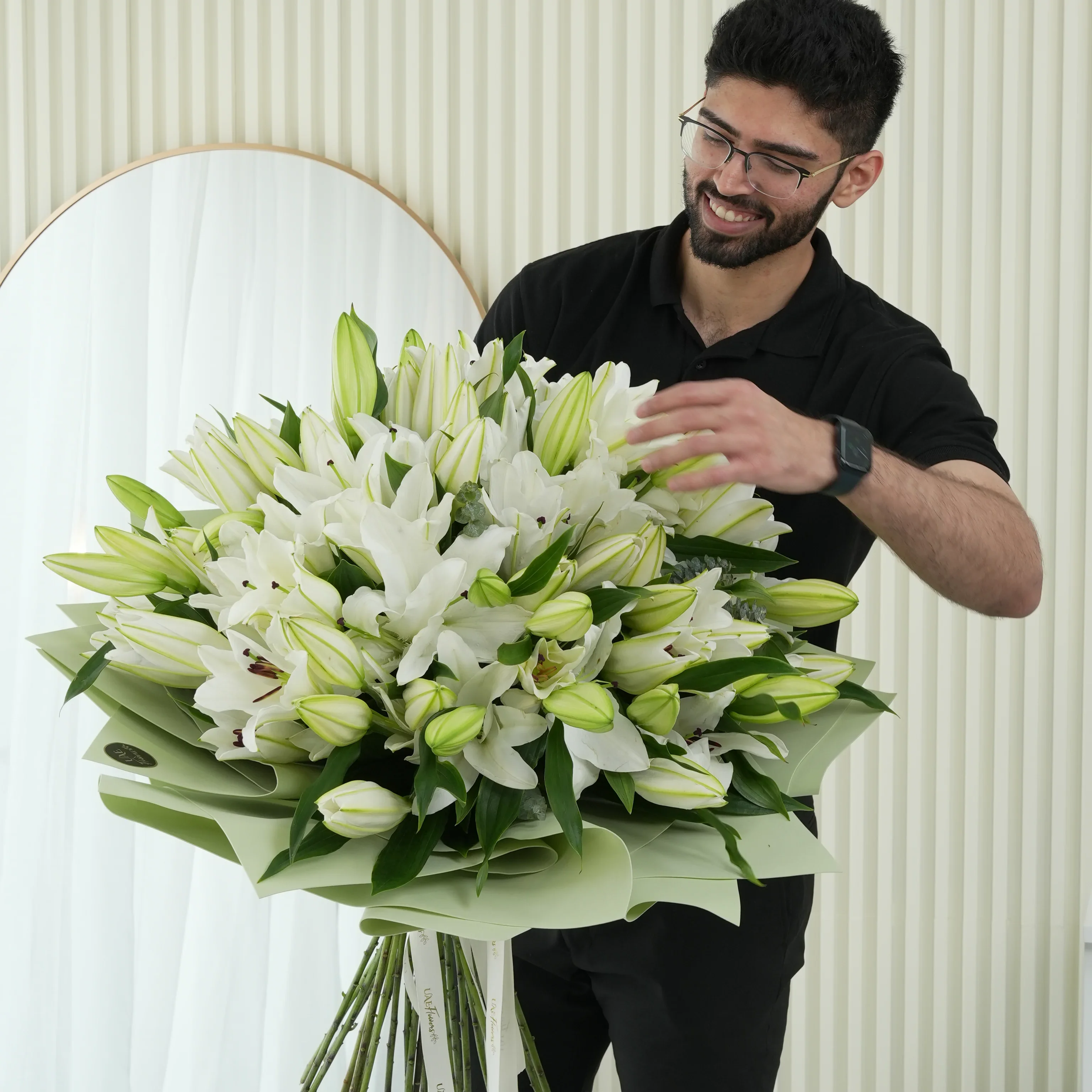 Bouquet of 20 white lilies with green fillers beautifully wrapped in pastel green wrapping paper.