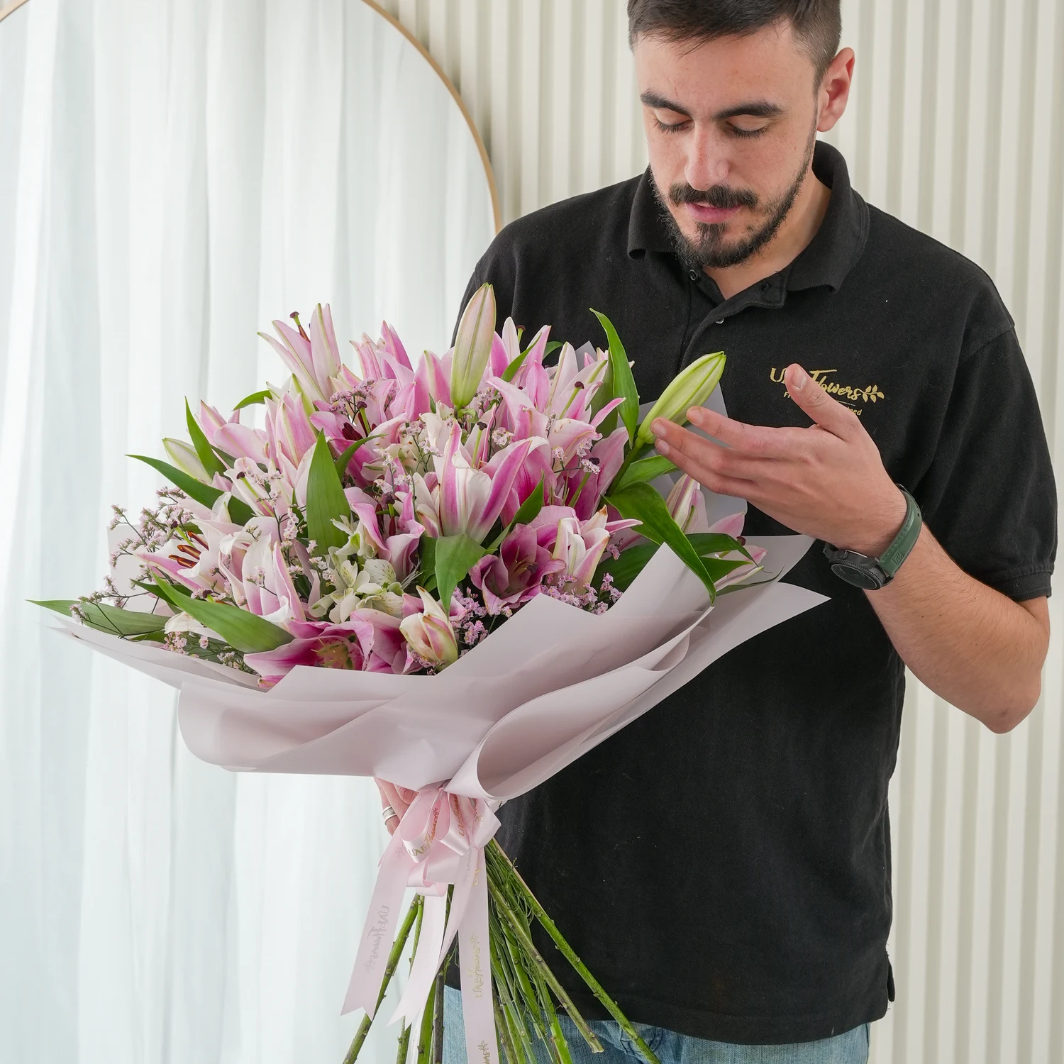 Bouquet of 10 pink lilies with green fillers beautifully wrapped in pastel pink wrapping paper.